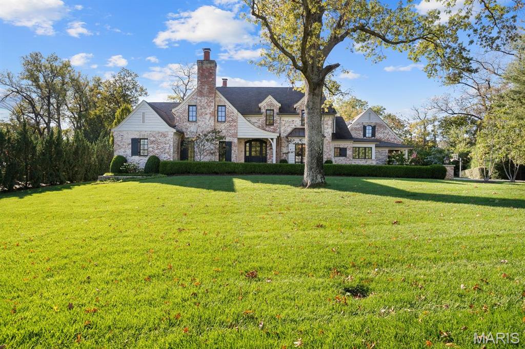 This exceptional property offers luxury, space, and timeless elegance on nearly one acre in one of Ladue’s most sought-after enclaves.
This stunning 7-bedroom, 6 full and 1 half bath residence boasts 6,856 square feet of beautifully finished living space designed for both grand entertaining and comfortable everyday living. From the moment you enter, you’ll be captivated by the impeccable décor, sophisticated finishes, and thoughtfully designed floor plan.
The expansive main level features gracious living and dining spaces, an open kitchen with premium appliances and custom cabinetry, and inviting gathering areas filled with natural light. Every detail has been carefully curated, creating a home that feels both refined and welcoming. Also located on the main level is the primary suite which boasts a gorgeous bath and generous walk-in closets. Upstairs, three spacious en-suites offer plenty of room for family or guests. 
The fully finished lower level elevates the home’s versatility, complete with two additional bedrooms, a full bathroom, large custom bar perfect for entertaining, a private office, and a spacious recreation room — ideal for hosting guests, movie nights, or game days.
A standout feature is the private guest apartment above the three-car garage, offering flexibility for extended family, au pair quarters, or long-term guests.
Step outside to your own backyard oasis featuring a sparkling pool, expansive patio space, and lush landscaping — all set on nearly an acre of beautifully maintained grounds.
12 Ladue Manor is the perfect blend of elegance, comfort, and functionality — a rare opportunity to own a truly remarkable home. EXCLUSIONS: Dining room chandelier and primary bedroom chandelier.
