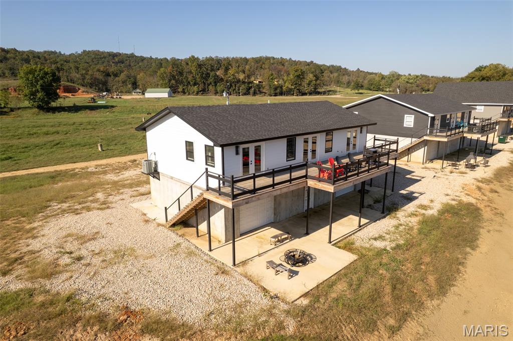 Home is a stunning newly constructed income producing 3 bed, 3 bath, riverfront home sitting off the bank of Current River.  This home comes with 100' of private river frontage with direct access to the water of the Ozark Scenic Riverways.  Sit on the magnificent back deck and enjoy the beautiful views and the beauty of nature and the river.  Inside the home, you will find a large open concept living/dining/kitchen adorned with crown molding, vaulted ceilings, granite countertops, stainless appliances and gorgeous views of the river.  There are 3 bedrooms, 2 of which have French doors for direct access to and from the deck.  The master bedroom is adorned with a spacious bathroom featuring an oversized step-in stone shower with glass doors.  This home comes complete with brand new furniture.  There are 2 drive-through garage doors for easy storage and access to your boats, kayaks, and more.  The lower level features a full bathroom along with plenty of storage area or entertaining area in case of inclement weather.   Whether you want to enjoy relaxing by the water, or on the water, fishing, kayaking, tubing or boating you can hit the river from your property.  Located just south of the bridge and north of Big Springs with many scenic areas to visit such as Peck Ranch, Cave Spring, Rocky Falls and local shopping and dining.  Whether you are looking for a full time residence, investment property, or a short term rental, this home will not disappoint.  Grab your phone and give me a call - the river is enjoyable year round and you don't want to miss out on this beauty.