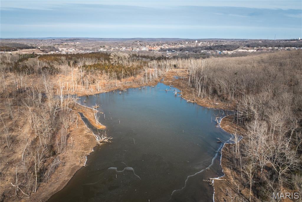 A great opportunity awaits with this remarkable 156.83 acre property offering the perfect blend of seclusion, natural beauty, and future potential. Anchored by a stunning 12-acre private lake, this tract features rolling terrain, and numerous premium build sites overlooking the water and surrounding landscape.
Whether you’re looking to create a private estate, develop income-producing rentals, establish a subdivision, or build a one of a kind recreational retreat for hunting, fishing, and outdoor enjoyment, this property delivers endless possibilities. As you enter the property, the front 5.26 acres sits within city limits along the right side of the road. The lake sits just off the main drive on the left, providing multiple scenic locations for a dream home or additional residences. Electric service is already in place near the entrance. With its combination of fantastic location, water, utilities, and development flexibility, this is a one-of-a-kind tract located near the heart of Potosi, MO is ready for your vision. Opportunities like this don’t come around often. Call today to schedule your private showing