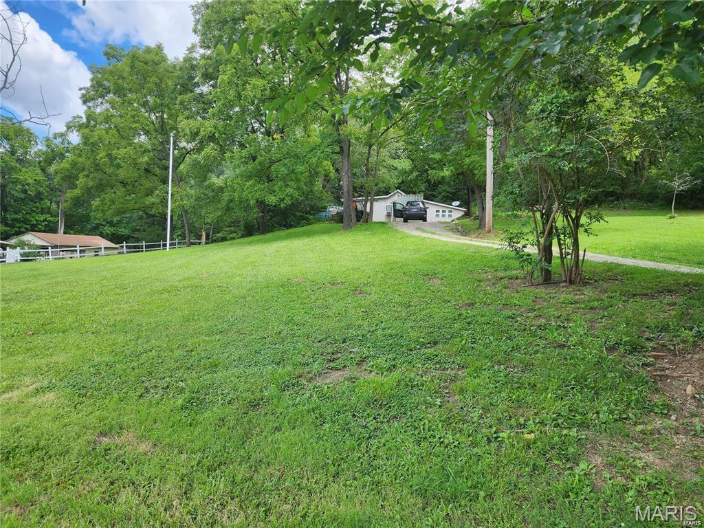 An exceptional investment opening has arrived in unincorporated St. Louis County! Boasting a highly coveted Kirkwood zip code and placement within the premier Parkway South school district, this unique property offers a 3-bedroom, 1-bathroom all-electric residence resting on an expansive lot of nearly three-quarters of an acre. The true prize here is the acreage itself, which delivers a peaceful, rustic ambiance right in the center of the county and backs directly up to protected railroad woodlands, ensuring permanent backyard privacy. With nearby new constructions easily exceeding the $400K mark, the premium land value makes this a goldmine for developers looking to potentially subdivide for one or two new builds, or for anyone wanting to start fresh with a custom dream design. The property utilizes a private septic system that avoids ongoing MSD fees, though it will require modern updates. Please note that this transaction is strictly unconditional, meaning it is being sold entirely in its current, as-is state with seller to make no repairs, replacements or do any inspections. Opportunities with this much geographic advantage and acreage are incredibly rare—reach out today to claim this site and start planning your next big project!
