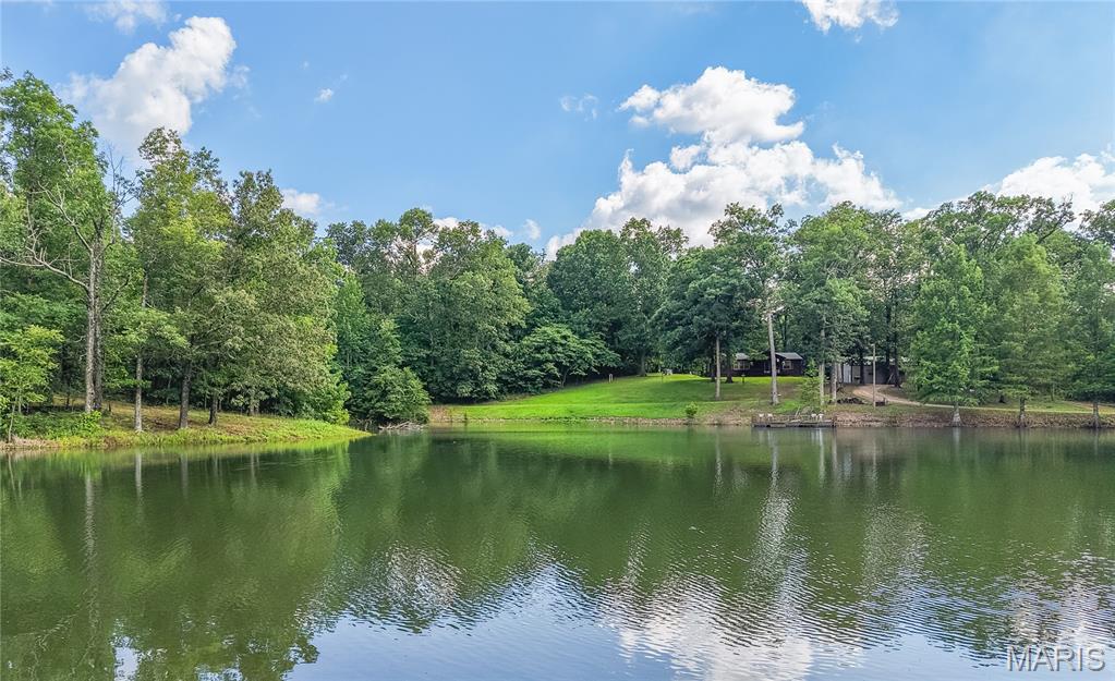 If you've been dreaming of the perfect country escape, this breathtaking 49 acre farm in Bloomfield is one you won't want to miss. From the moment you enter the property, you'll understand what makes it so special. A winding driveway gracefully wraps around a stunning 3 acre, picture perfect pond, creating an unforgettable entrance that feels like something out of a magazine. The property features a charming 2 bedroom, 2 bathroom home that's perfect as a full time residence or weekend retreat. A heated and cooled 30x40 shop provides exceptional space for hobbies, equipment, or storage and even includes its own bathroom for added convenience. Outdoor enthusiasts will fall in love with the established trail system that winds throughout the property, making it ideal for ATV riding, hiking, hunting, or simply enjoying everything nature has to offer. With multiple beautiful building sites, this farm also offers the opportunity to build your dream home while keeping the existing home as a guest house, or family retreat. Whether you're searching for a peaceful place to call home, a recreational paradise, or a property with endless possibilities, this one checks all the boxes.