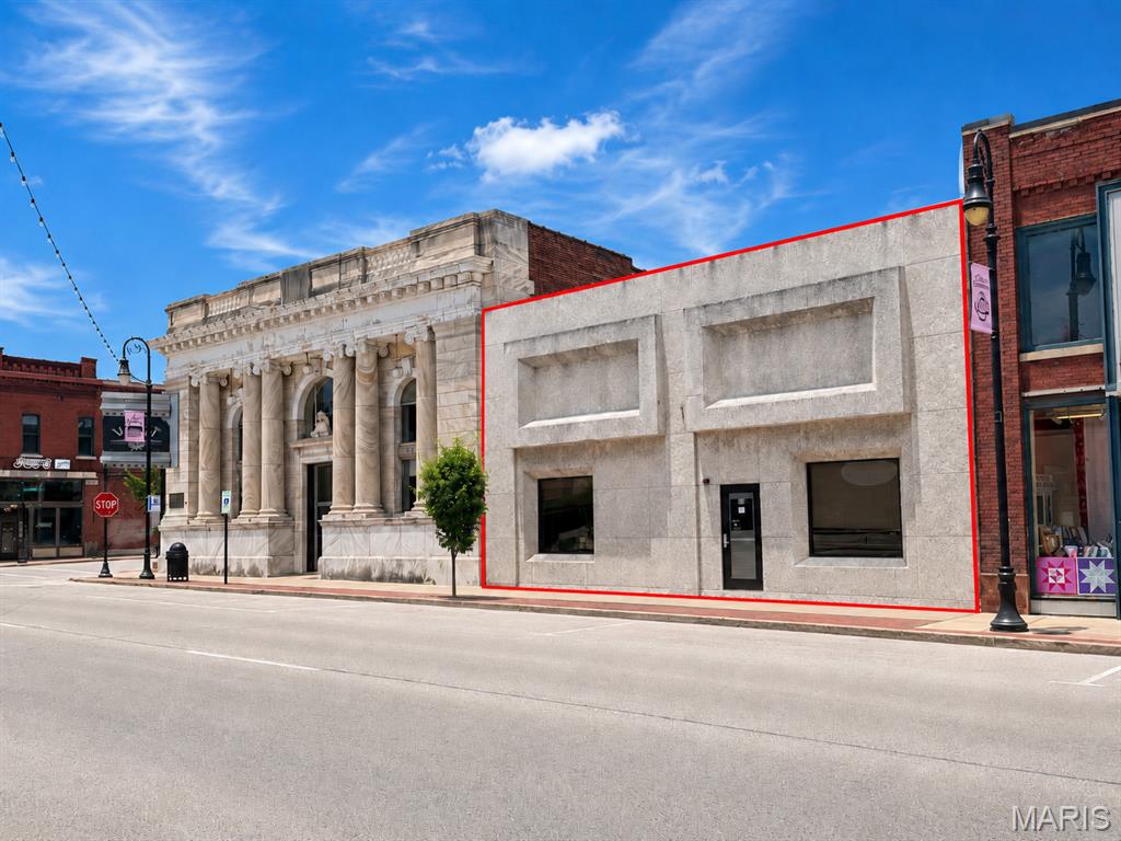 Located in the heart of Uptown Collinsville, this distinctive downtown commercial property offers strong visibility along West Main Street and a flexible layout suitable for a variety of business concepts. The property features an attractive street presence, large storefront windows, multiple entrances, tall ceilings, exposed architectural elements, pendant lighting, display cases, and a spacious open interior that can be adapted for retail, office, studio, showroom, service, or other commercial use. Additional areas provide storage, utility space, and access toward the rear of the building. Surrounded by established businesses, restaurants, community destinations, public parking, and pedestrian-friendly sidewalks, this property offers an excellent opportunity for an owner-user, investor, or entrepreneur seeking a prominent location in Collinsville’s downtown district. Property is being offered in its current condition. Buyers should independently verify square footage, zoning, permitted uses, building systems, parking, and all other information important to their intended use.