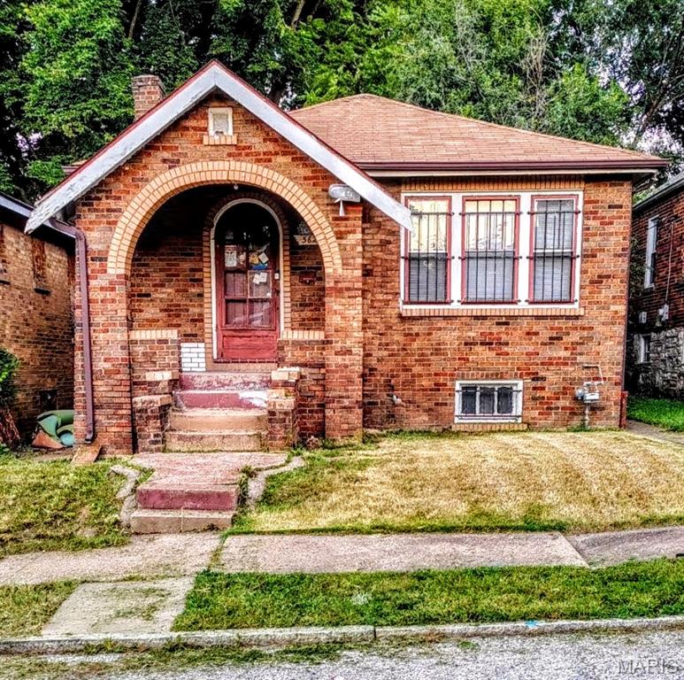 Here's a Quicker Fixer Upper! Step into the timeless charm of this classic Spanish-style brick bungalow, where architectural character and everyday convenience come together. From the inviting Brick Archway that welcomes you onto the front porch to the distinctive decorative glazed brick masonry, this home offers curb appeal that stands out from the ordinary. Inside, you'll find hardwood floors, 2 bedrooms, separate dining room and stunning stained-glass windows that fill the foyer and living room with warmth and character. The thoughtful floor plan combines vintage craftsmanship with practical living spaces, making this property ideal for homeowners seeking a unique residence, investors looking for a highly desirable rental opportunity, or to fix and flip. Additional features include a full walk-out basement offering abundant storage and future possibilities, as well as a detached oversized garage.  Location is another exceptional advantage. Situated in a highly walkable neighborhood, you'll enjoy easy access to everyday conveniences. Elementary school, Herzog Park, Lions Park, and Neighborhood Grocery
Stores are all just a short stroll away. Commuters will appreciate the home's proximity to public
transportation and quick access to Interstate I-70, providing convenient connections throughout the region. Properties with this level of architectural character, walkability, and accessibility are increasingly difficult to find. Whether you're searching for your next home or a smart investment opportunity, this charming bungalow deserves your attention. Schedule your private showing today—opportunities like this do not stay on the market for long! The home is being sold AS-IS; The seller will not provide any reports or perform any repairs. including municipal occupancy. A Hold Harmless will be completed before entering the home. Owner is a Realtor. No sight unseen offers.