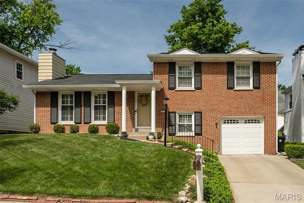 Welcome to Kirkwood living at its finest! Nestled in the highly sought-after Osage Hills/Greenbriar neighborhood, just moments from Greenbriar Hills Country Club and golf course, this move-in ready 3 bedroom, 2.5 bath exudes pride of ownership and offers the perfect blend of location, space, and lifestyle. The main level is graced with beautiful hardwood floors and includes a comfortable living room with slate fireplace that opens seamlessly to the spacious dining room--a perfect layout for entertaining or just relaxing at home. The charming eat-in kitchen includes crisp white cabinetry, granite countertops and stainless appliances. Upstairs, you will find a primary suite with ensuite full bath, 2 additional bedrooms and a second full bath. The lower level gives you more living space to enjoy in the cozy family room with custom cabinetry and a cheerful built-in window seat, plus a half bath. The private, fully fenced backyard provides a tranquil oasis with a WOW-FACTOR and is a true extension of your everyday living. Entertaining is a breeze on the spacious brick-paved patio that includes an impressive custom stone fireplace with stone bench seating and built-in lighting. Noteworthy: NEWER windows and interior doors throughout, tasteful plantation shutters on ALL windows, fresh paint throughout (2025), new roof (2020). In addition, enjoy the perks of neighborhood tennis courts and the convenience of being just steps away from a bird sanctuary and Monfort Park that includes playgrounds, a pavilion and walking path. This is more than a pristine home, it's a lifestyle!