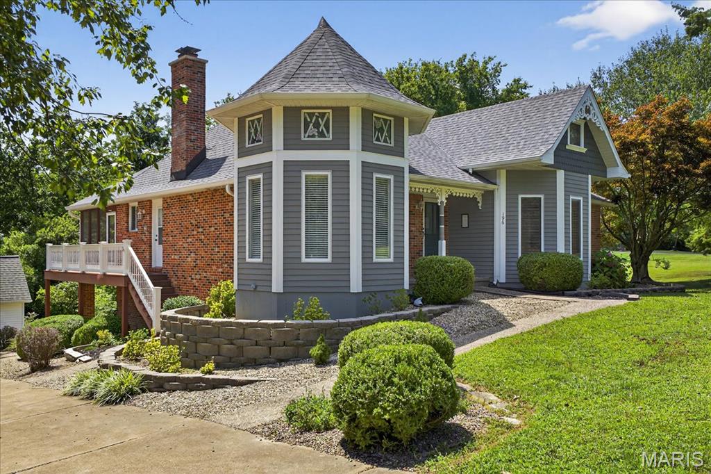 Final sale price is reflective of $21,000 reduction/concession given by seller as septic needed replacement. This charming Victorian style home sets on a wooded 2.66 +/- acre mini estate that offers many opportunities for expansion and multiple uses with its 3 outbuildings and large attic area that is currently unfinished, but does have stair access from the foyer. Imagine using one of the sheds as a gardening/greenhouse or a woodworking shed that is nestled along a stone path with access to a 3rd garage building. The flowers and trees stay green and pretty with the sprinkler system. The home features two wood burning stoves one on each level. The kitchen is a cook's delight with stainless steel appliances and access to huge covered screened in porch that is perfect for entertaining. The primary suite has a ten foot ceiling and private bath with his and hers sinks and closets. The Lower Level features two entertaining areas that could be a TV/Media room, exercise room or family room. There is a wet bar and walk-out access to huge covered patio. A lovely opportunity awaits you here!