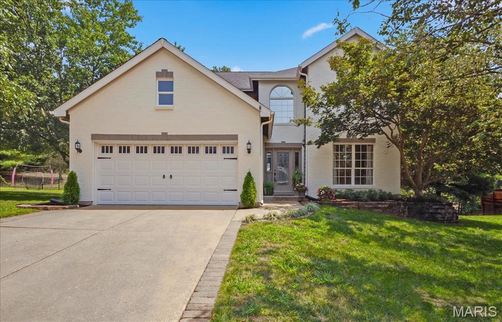 Saturday open house (09/12), 12:00 - 2:00 p.m.  Welcome to this attractive 2-story home, located on a cul-de-sac, with 4 bedrooms, 2.5 bathrooms and partially completed lower level.  Lots of natural light.  Spacious backyard with large deck (22x19) ideal for gatherings or quiet evenings.  Roof (03/2026), siding (02/2026), deck stained (08/15/2026).  The 2-story foyer opens to the dining room with gleaming hardwood floor and built-ins.  The family room features a wood-burning fireplace, built-in shelves, gleaming hardwood floor, bay window and ceiling fan.  Opens to the spacious kitchen and breakfast area with custom cabinetry, gas stove, island/breakfast bar, built-in microwave, pantry and planning desk.  Leads out to the deck.  Main floor laundry room with countertop and cabinets.  All 4 bedrooms on the second floor with 2 full bathrooms.  The primary bedroom has a vaulted ceiling, walk-in closet and luxurious bathroom with double bowl vanity, tub and separate shower.  The partially finished lower level offers a game area with pool table, entertaining space with built-in countertop/ cabinets and storage room.  Attached 2-car garage.  The deck will be stained prior to closing.  Neighborhood amenities include:  Clubhouse, pool, tennis/pickleball courts, lake, walking trails.  Access to miles of beautiful Wildwood hiking/biking trails.  Convenient to shops/restaurants.  Minutes to Wildwood Towne Center.  Rockwood school district.