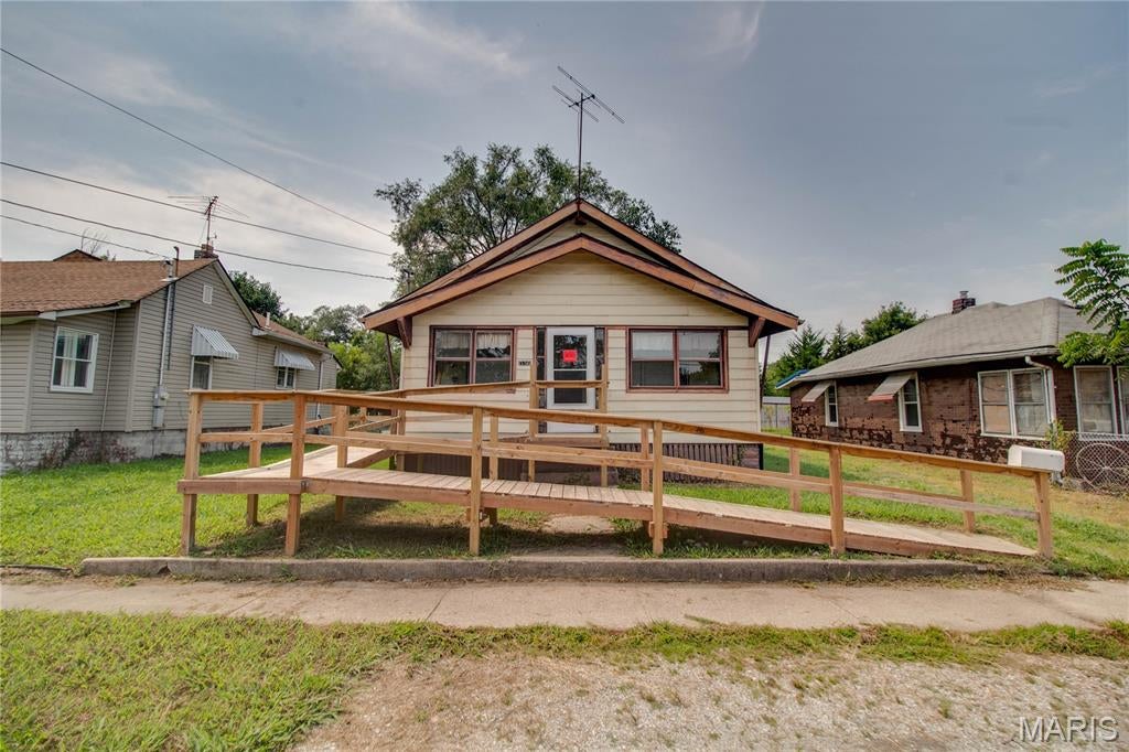Calling all rehabbers, investors, and experienced buyers! This 2-bedroom, 1-bath home is a true opportunity for someone who can see beyond its current condition and bring its potential to life. The property has been condemned by the City, and a list of required repairs is available for review. Inside, you'll find a functional layout with a living room, dining room, eat-in kitchen with walk-in pantry, two bedrooms, and a full lower level offering additional potential. The enclosed front porch, attic storage, fenced backyard, alley access, and wheelchair ramp add even more possibilities. This is not a turnkey home—it will require significant work—but for the right buyer, the upside could be substantial. With a strong potential ARV and plenty of room to add value, this could be the project you've been looking for. Bring your vision, your contractor, and your imagination!