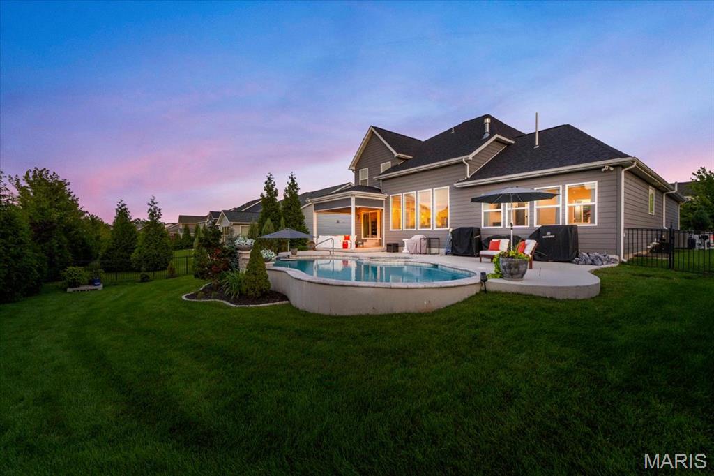 Pool days, movie nights, front porch evenings and golf cart rides through beloved Fienup Farms define life at 16955 Pine Summit. Built by Consort Homes in 2019, this coveted expanded 1.5-story residence offers five bedrooms, four-and-one-half bathrooms and an exceptional layout designed for both everyday comfort. The main level features a spacious primary suite with an oversized walk-in closet, expanded shower, soaking tub and motorized retractable blinds. A dedicated office with built-in shelving provides an ideal work-from-home setting, while the home’s open living spaces flow effortlessly to the outdoor entertaining areas. The professionally landscaped backyard is a private retreat featuring a heated Blue Haven pool and spa, retractable screened porch with television and a firepit area ready for smores and laughs. An expansive covered front porch offers another perfect place to unwind and enjoy the golf cart friendly neighborhood. Upstairs, three generously sized bedrooms each include walk-in closets, complemented by a Jack-and-Jill bathroom, an additional en suite bathroom and a versatile loft. The finished lower level was made for movie nights and college football games with a built in projector and sound system, complete with a spacious recreation area, full bar, additional bedroom and full bathroom. A new roof installed in 2025, zoned HVAC system and whole-home generator provide added comfort and peace of mind. With resort-style outdoor living, a highly desirable floor plan and a golf-cart-friendly setting in one of Chesterfield’s most beloved communities, 16955 Pine Summit delivers a lifestyle that is difficult to replicate.