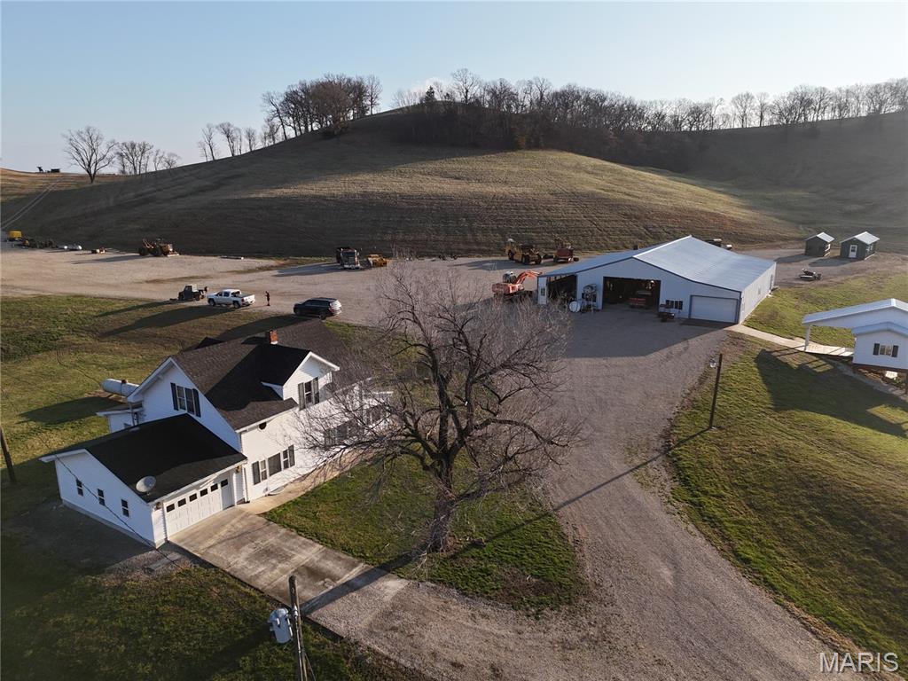Here is a rare opportunity to own 78+/- acres overlooking the Mississippi River and Ted Shanks Conservation Area. This property includes a 4 bedroom, 1 bathroom farmhouse built in 1918, along with a garage and two machine sheds for storage or equipment. This land is a hunter's dream, with established food plots, abundant deer, and diverse terrain including woods, rock bluffs, caves, and riding trails. A pond with a custom amish built shanty over the water creates the perfect spot to relax and enjoy the peaceful surroundings. Bordering conservation ground, this property offers incredible views, excellent hunting, and endless recreational opportunities. A truly unique piece of Pike County countryside.