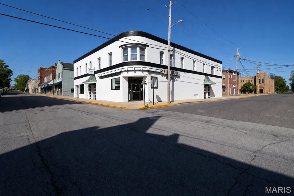 Build your business. Grow your portfolio. Plant your roots in Downtown Washington, MO.
The Schroeder Building at 203 Elm Street offers TEN units and 11,847 total square feet in the heart of one of Missouri's most active and recognized downtown districts. Income from day one.

A building that remains a memory for many locals and holds a rich history in the Downtown Washington District.  The building has been extensively renovated, keeping some historic charm while giving it a modern spin.  Three ground-floor commercial suites anchor the building. Suite 100 is 2,650 SF. Suite 100A is 2,250 SF. Suite 101 is 2,100 SF with a multi-office floor plan and a ground-floor address on Elm Street. Seven fully occupied one-bedroom apartments sit above, ranging from 635 to 812 square feet, and rent from $850 to $920 per month. All apartment leases carry automatic 12-month renewal provisions. The residential side runs itself.
2025 net operating income was $70,299. Full financial package available on request. All appliances are included with the sale.

Washington is the largest city in Franklin County, home to more than 15,000 residents and growing. Over 60 industries operate here. The city serves as the retail, medical, and banking hub for the entire county. Downtown Washington is a Main Street America-accredited district with year-round foot traffic to back it up. Art Fair and Winefest draw visitors from across the Midwest every spring. WashMo BBQ and Bluesfest, Sunset on the Riverfront, the Fall Festival of the Arts, and the Holiday Parade of Lights. The calendar stays full. The streets stay busy. This building sits in the middle of all of it.

Suite 101 is vacant and ready. Professional office, financial services, legal, wellness, title, creative agency. The floor plan is multi-office today. The right occupant makes it their own. City occupancy inspection passed in December 2025. Zoned C-3. This opportunity doesn't come up often for the public.  Let's make your business bloom!  Make this your investment property TODAY.  PLEASE DO NOT DISTURB TENANTS.