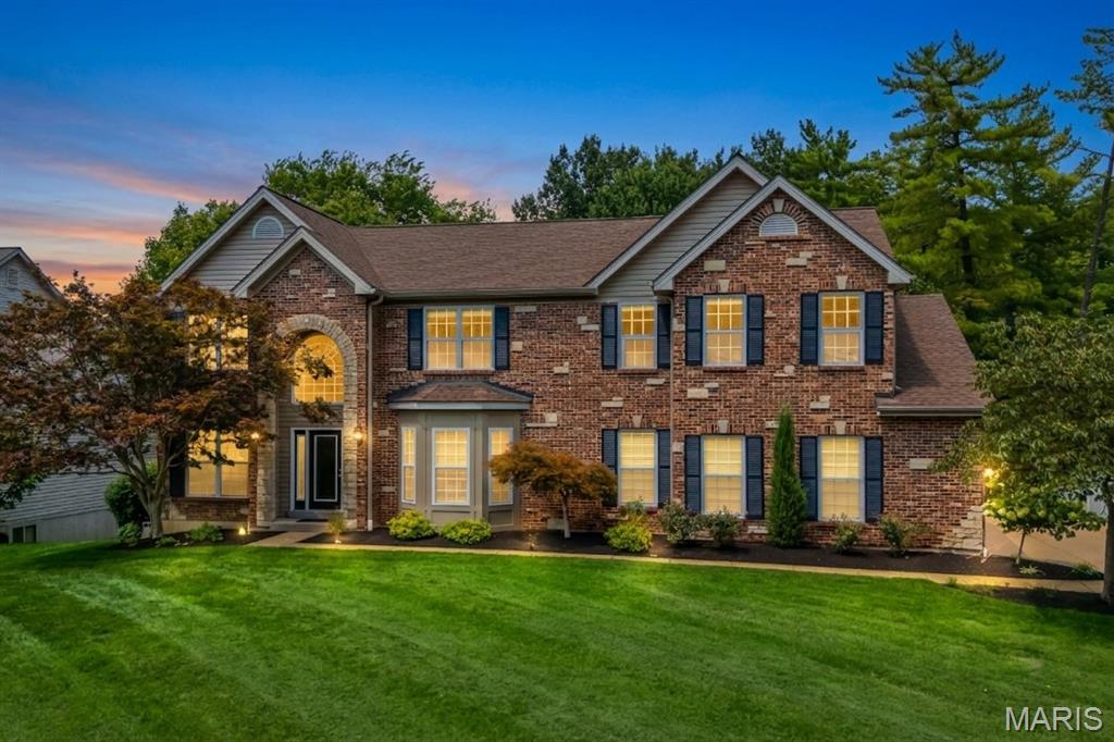 Introducing 7 Graeser Acres, a beautifully updated 5-bedroom, 4.5-bath luxury home in St. Louis County’s sought-after Ladue School District. Built in 2004, this traditional brick-front residence offers 4,783 square feet of finished living space, a .46-acre setting, and a side-entry 3-car garage. A soaring two-story foyer immediately showcases Brazilian cherry floors, detailed millwork, crisp white crown molding, and abundant natural light.

On the main floor, a gracious living room, formal dining area, intimate fireside sitting room, and sunlit breakfast nook balance open flow with well-defined zones. The gourmet kitchen features custom cabinetry, granite countertops, a center island, premium stainless steel appliances, double ovens, and a new high-end gas range. Generous proportions and thoughtful sightlines support daily routines or larger gatherings with ease. Three fireplaces add warmth and architectural character throughout.

New hardwood extends through all four second-floor bedrooms. The spacious primary suite includes an adjoining home office or private lounge, oversized walk-in closet, and spa-inspired bath with dual vanities, soaking tub, and separate shower. Three secondary bedrooms, two additional full bathrooms, a versatile loft, and upper laundry complete this exceptionally functional arrangement.

The 1,210-square-foot finished walkout basement substantially broadens the possibilities. A true fifth bedroom with egress and a closet, full bath, expansive family room, flexible bonus room, new tile, direct exterior access, and considerable unfinished storage accommodate overnight visitors, recreation, fitness, remote work, or hobbies without compromising the spaces above.

Outdoor living centers on a two-tier paver patio overlooking a koi pond, arched bridge, cascading waterfall, mature landscaping, and broad flat lawn. The result is a memorable backyard retreat equally suited to quiet mornings, relaxed evenings, or lively entertaining.

Behind the polished presentation is meaningful investment in the major systems. Two furnaces were installed in 2026, the roof was replaced in 2021, both air conditioners are approximately five years old, and both water heaters were replaced about two years ago. Further advantages include an owned security system, integrated sound, ample closets, and extra driveway parking.

Move-in ready and meticulously prepared, this distinctive property delivers substantial scale, versatility, craftsmanship, and landscaped grounds in equal measure.