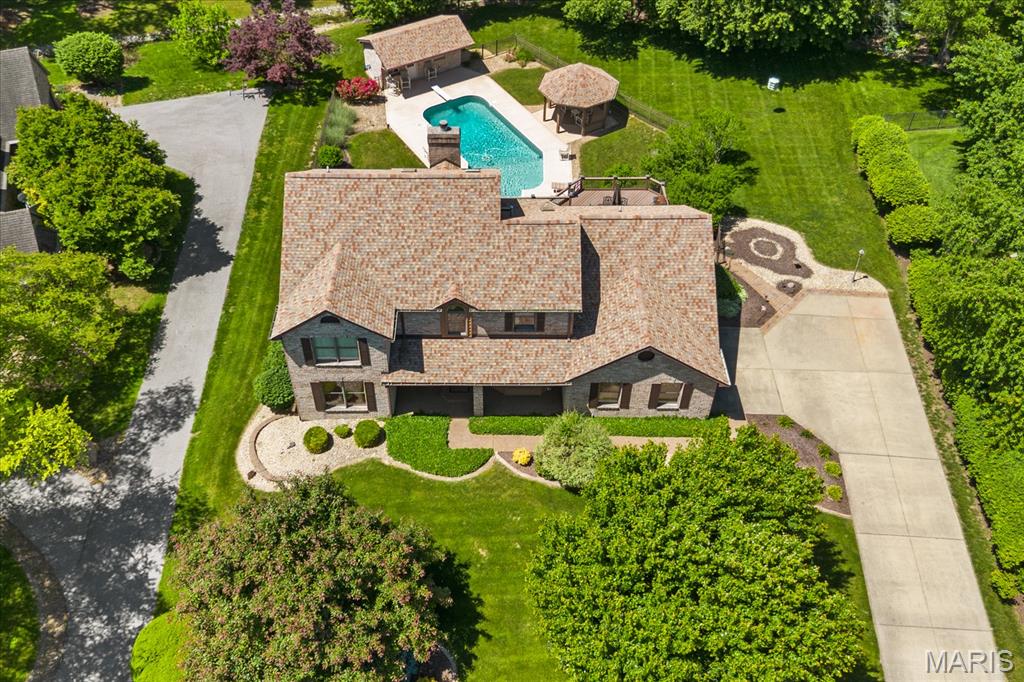 Welcome to #9 Calypso Court, located in Chenot Place, one of the area’s most sought-after neighborhoods, where elegance and lifestyle come together beautifully. From the moment you arrive, this stunning one-and-a-half-story home makes an unforgettable first impression. Professional landscaping perfectly complements the striking brick exterior and warm wood accents, creating incredible curb appeal. Inside, the heart of the home is a chef-inspired kitchen featuring premium stainless-steel appliances, a center island, and abundant cabinetry. Whether you’re hosting formal dinners in the dedicated dining room or enjoying casual meals in the breakfast area, this home was designed with entertaining in mind, especially when it’s time to host unforgettable parties. The spacious living room is highlighted by soaring ceilings and a dramatic lofted overlook, creating an open yet inviting atmosphere. Comfort continues throughout the home, from the main-floor primary suite to the expansive lower level featuring a massive family room with built-in wet bar, private office, and fourth bedroom with a three-quarter bath.
But the true showstopper is outside. Step onto the walk-out patio or upper deck and into your own private resort-style retreat, complete with an incredible inground pool, a gazebo, expansive decks, and a pool house all designed for the ultimate summer gatherings. With four bedrooms, four baths, and an outdoor oasis that’s hard to match, this is more than a home - it’s a lifestyle. Schedule your private tour today.