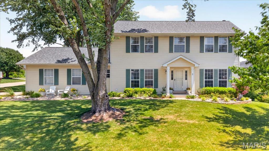Welcome home to this beautifully updated 2-story in the highly sought-after Monticello neighborhood of O'Fallon! Situated on a spacious corner lot shaded by mature trees, this 4-bedroom, 3.5-bath home offers the perfect blend of comfort, style, and functionality. The main level features luxury vinyl plank flooring, a spacious living room with stunning custom built-ins and a cozy fireplace, a formal dining room, and a beautifully updated kitchen with quartz countertops, white cabinetry, subway tile backsplash, center island, and stainless steel appliances. French doors lead to a versatile flex space perfect for a home office, sitting room, or playroom. Upstairs, the generous primary suite offers a beautifully renovated bath complete with dual vanities, freestanding soaking tub, and modern finishes. Three additional bedrooms provide plenty of space for family and guests. The finished walkout lower level expands your living space with a large family room, full bath, office or sleeping area, and abundant storage. Step outside to enjoy the private backyard retreat featuring a low maintenance deck, custom paver patio,  and mature landscaping—ideal for entertaining or relaxing.  With neighborhood amenities including pools, clubhouse, pickleball, tennis courts, and walk trails, this stunning home located just minutes from parks, schools, shopping, dining, and major highways offers the space, updates, and location you've been waiting for.