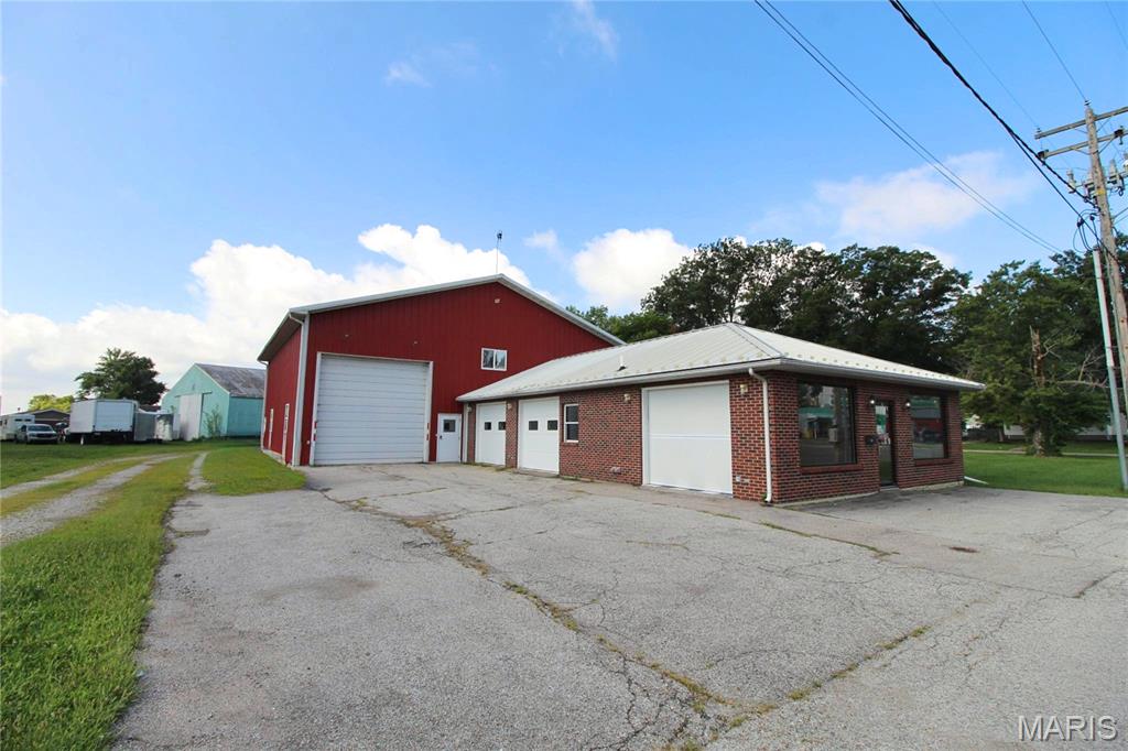 Turnkey automotive business opportunity with living quarters, located in the heart of New Athens, IL! This well-equipped shop sits along Spotsylvania Street, a main corridor through this close-knit St. Clair County village along the Kaskaskia River, about an hour from downtown St. Louis. The property features 4 drive-in bay doors, a spacious customer lobby with front reception desk, dedicated paint booth, and an overhead lift/crane system ready for immediate use. Small on-site parking area accommodates customer and staff vehicles.

Upstairs, 350 sq ft second-floor living space offers a eat-in kitchen, living room, 2 bedrooms, and 2 full bathrooms, ideal for an owner-operator, rental income, or on-site management. Sale includes all equipment, tools, and furniture, making this a true turnkey opportunity for an established shop, new business owner, or investor.

Don't miss this rare combination of commercial workspace and residential living under one roof. Schedule your showing today!