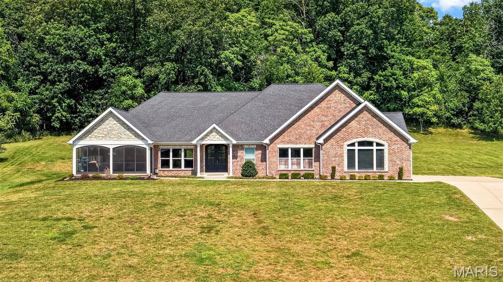 Welcome to paradise! This spectacular home awaits you in the prestigious, gated Augusta Shores Subdivision. This stunning 2,660 above grade square-foot home with over 3800 feet of total living space offers unobstructed, breathtaking views of Berg Pond, Klondike Park, and the entrance to the iconic Katy Trail. Soak in those gorgeous views year-round from the dining room, primary bedroom, living room, kitchen, and the beautiful, oversized screened porch. Space, style, and sophistication come together in a thoughtfully designed open-floor plan, making this home as functional as it is breathtaking. No detail was overlooked!

So many features! The kitchen is a showstopper, featuring custom-made, Amish-crafted cherry wood cabinets, quartz countertops, stainless steel appliances, and a walk-in pantry. Arched doors and doorways and rich red oak hardwood floors flow seamlessly from room to room. The primary suite bath is your personal retreat, featuring lighted Kohler mirrors, a walk-in shower with dual shower heads — including a luxurious rain shower and the primary bedroom has a walk-in closet, along with an additional closet and remote-controlled shades. A jetted tub highlights the secondary bath, while a walk-in butler’s pantry with extensive cherry wood cabinetry, a wet bar, and an ice machine makes entertaining an absolute dream. Additional highlights include a floor-to-ceiling remote controlled fireplace, tinted windows, tray ceilings, and pocket doors.

Head downstairs on an extra wide oak staircase and prepare to be wowed! The lower level features a large recreation room with a simply phenomenal custom-built bar and expansive custom-made bookshelves. Also on the lower level: a full bath, an additional bedroom, a dedicated fitness room, and a large unfinished basement area for all of your storage needs.

Outside, the property backs to trees and includes a full irrigation system, exterior lighting, three Ring cameras, and an invisible fence for your four-legged family members. And don’t forget the subdivision’s swimming pool, pickleball courts, and walking trail — plus four bass and catfish filled lakes in Augusta Shores for fishing enthusiasts! The subdivision also offers free boat storage, or you can store your boat in the insulated oversized side entry three car garage.

This one-of-a-kind home is heated and cooled by an energy-efficient geothermal system — saving you hundreds and hundreds of dollars every summer and winter!

Properties like this don’t come along twice — make this paradise your home!