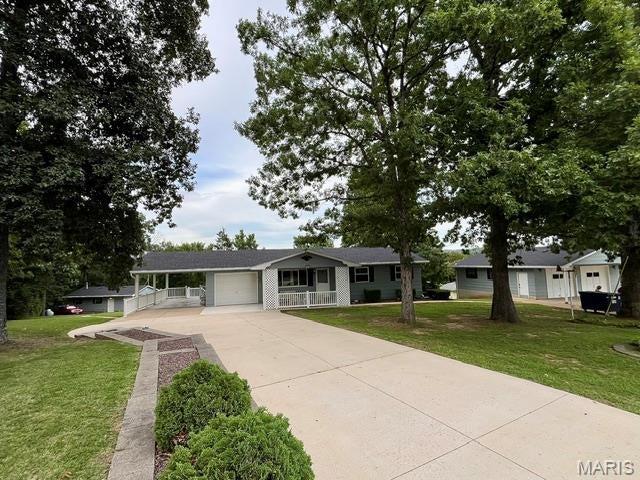 This Is An Amazing Estate That Has Been In The Family For Years, and Always Meticulously Maintained!   A Modest and Clean Ranch Home Is Beautifully Positioned Providing Plenty Of Distance From Local Hillsboro Road!  Security System and Cameras In Place!  There Are 6 Garages!  Defined By Newer, Double Wide Concrete, This Driveway Supports All The Parking You Need For Family and Friends!  Mature Trees For Beauty and Shade, An Accent Stone Planter Wall and A Covered Front Porch Also Has Newer Concrete That Looks Fabulous, Just Terrific For Relaxing!  An Attached Garage For Easy Access To The Home, Plus An Extended Carport With A Park Like View! The Updated and Orderly Kitchen Hosts An Electric Range, Side By Side Refrigerator, Bosch Dishwasher, Double Bowl Kitchen Sink, Newer Faucet and Plumbing, Pantry, Plenty Of Countertop Space and A Kitchen Window!  Kitchen/Dining Combo Has A Ceiling Fan and Window That Overlooks The Mostly Private Yard!  You Will Find A Small Doggie Door For Convenience To The Future Family Pet and A Separate Entrance From The Garage To The Dining/Kitchen Area!  Originally The Home Was Built As A 3 Bedroom and Was Converted Into A 2!  There Is A Hallway Linen Closet and An Attic Fan!  The Master Bedroom Has 2 Front Windows, Ceiling Fan, A Large Closet and A Huge Walk In Closet With Bifold Doors and Custom Shelving!  The 2nd Bedroom Has Mirrored Closet Doors and A Window With A Backyard View!  The Bathroom Features A Walk In Shower, Glass Doors, Linen Supply Closet, Updated Lighting and Cabinetry!  There Is a Stair Lift In Working Order, Very Useful and Clean Even If Used To Take Your Laundry Upstairs!  An Open and Large Family Room Is Great For Hanging Out Watching Movies, Playing Cards Or Tinkering With Your Choice Of Hobbies!  There Is A Full Bathroom Which Is Super Convenient, Closet Storage With Lighting and A Patio Slider Leading To Your Oversized Patio!  An Immaculate and Huge Laundry Room That Has Custom, Built-In Shelving Units, HWH, Furnace, W/D, Smoke Alarm, Newer 200 AMP Panel Box and A Second, 100 AMP Panel Box!  The Alarm Is Owned, Dayton Is The Name!  There Is A Water Filter System In Place and Functioning!  The Rectangular Space Not Painted Is Where A Safe Was Kept!  There Is A Detached 2 Car Garage That Has Heating, Franklin Stove, Cooling, Oversized Garage Door, Exhaust Fan, LED Lighting, Water, Separate Entry Door, Windows With Screens and Bars!  Attached To This Garage Is A Large Custom Built, Walk In Cage Excellent For Items Needing To Be In Safe Keeping, Concrete Floor and Adjacent Is A Single Door Garage Utility Room Ideal For Lawn Equipment To Be Stored!  Additionally, There Is A 2 Car Oversized Garage That Faces Local Hillsboro Road!  This Is Where A Family Business Known As NSA Auto Maintenance Was Operating For Years!  This Is Such A Gem To Have With 2 Separate Garage Doors, Side Entry Access Door With Keypad Lock, 1/2 Bathroom, Heating ADP/Cooling/Water and A Corner Kitchen Area With Plenty Of Cabinets!  There Is An Air Compressor, Attic Fan, 4 Windows With Safety Bars, 100 AMP Panel Box, Landline Phone, Air Compressor, Electric Cord Pulley's and Numerous Shelving Units!  This Estate Has Been A Family Gathering Place For Years and Now, It's Time For A New Owner!  This Is A Rare Find and A Must Have For Those Who Have and Like Nice Things!