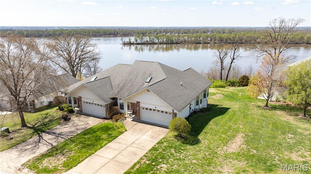 Enjoy stunning river views from this highly sought-after villa, nestled above the Mississippi River. This 3-bedroom, 3-bathroom home features an open-concept layout, vaulted ceilings and abundant natural light throughout the home. Some new fixtures through out the home. The attached 2-car garage walks into the kitchen—perfect for everyday convenience. Primary suite offers breathtaking views of the river, a spacious walk-in closet, and a well-appointed bathroom. You’ll also appreciate the main-floor laundry as a plus! Entertain or relax on the walk-out deck while taking in panoramic views. The finished lower level adds more living space with a cozy fireplace, an additional bedroom, bathroom and access to a covered concrete patio. Plenty of storage for a hobby space in the utility room. HOA takes care of the roof, lawn care, trash service, exterior window washing, and more—making low-maintenance living a breeze! Enjoy the convenient subdivision clubhouse which offers an inground pool, workout area, and more!