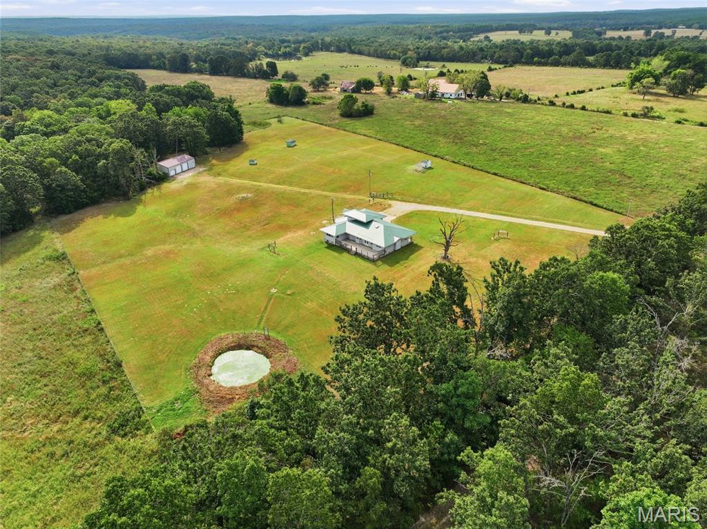 Escape to the peace and privacy of country living with this beautiful 5-bedroom, 2.5-bathroom home situated on 8 acres. Surrounded by open pasture and a touch of woods, this property offers the space, versatility, and quiet setting you’ve been searching for, complete with thoughtful custom details throughout.

Step inside to a warm and inviting interior where hardwood flooring adds timeless character and craftsmanship shines from room to room. The spacious kitchen is designed for both everyday living and entertaining, offering plenty of room to gather along with stainless steel appliances and generous workspace.

The impressive primary suite provides a private retreat at the end of the day. Its oversized bathroom features a beautiful clawfoot tub, walk-in shower, and walk-in closet, creating the perfect blend of charm, comfort, and functionality. With five bedrooms, there’s plenty of flexibility for family, guests, home offices, or hobby spaces.

Outside is where this property truly stands apart. The 8 acres are flat and primarily pasture, providing endless possibilities for animals, recreation, gardening, or simply enjoying wide-open views. A wooded area near the shop adds privacy and natural beauty to the landscape.

For those needing serious workspace or storage, the approximately 1,500-square-foot shop with electricity is ready for equipment, projects, hobbies, or a home-based operation.

Experience the space and serenity this one-of-a-kind country property has to offer. Schedule your private showing today and discover everything this acreage property has waiting for you!
