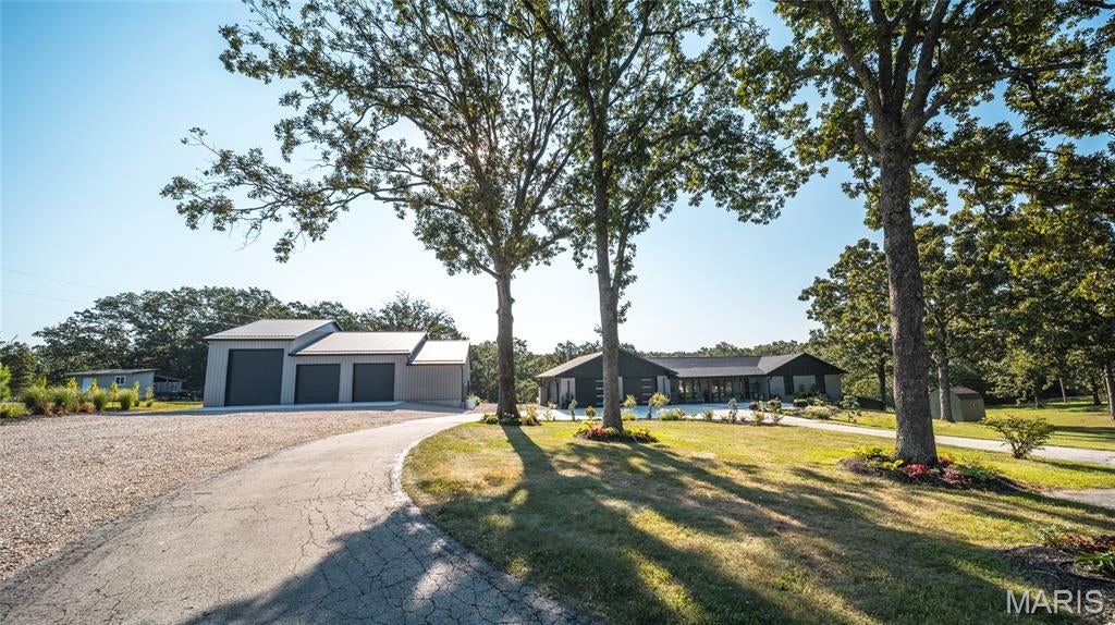 This completely transformed 2-bedroom, 2-bathroom modern masterpiece sits on 5 private acres within the highly sought-after Spring Bluff School District. Stripped down to the studs and rebuilt with premium modern finishes, this property offers the perfect blend of luxury, functional acreage, and country peace.   Magazine ready - Ladies, this home is curated with beautiful engineered wood floors, gradient tiled kitchen walls, white oak stairwell, stainless steel and polished gold appliances,  a master bath to die for.. laundry in the master walk-in closet.    Gentleman,  a 50 x 45 detached outbuilding that will hold all the toys, including the RV!  A 50 x 15 rec room steps off the detached garage with bathroom and kitchenette,  44 x 12 composite deck over looking the 5 acres and the above ground pool.   All this can be yours!