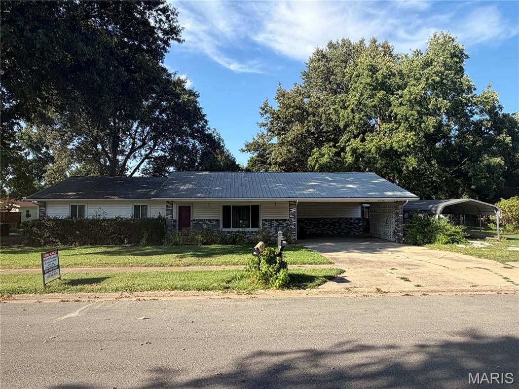 Welcome to 545 St. Paul in New Madrid, Missouri. Located in the area locally known as the “Holy Land,” this one-story home offers approximately 2,064 square feet of living space with 3 bedrooms and 2 bathrooms.

The home features a combination of brick and siding exterior, a metal roof, central heating and air conditioning, and an attached carport. A screened-in porch provides a comfortable space for relaxing, entertaining, or simply enjoying the outdoors.

Situated on an approximately 168' x 130' lot, the property offers a spacious yard with mature landscaping and a wonderful variety of fruit-producing trees, including pear, fig, peach, plum, apple, and cherry trees. Additional features include covered parking and a detached utility building for extra storage.

With over 2,000 square feet of living space, a large lot, screened-in outdoor living space, established fruit trees, and additional storage, this property offers plenty of room both inside and out.