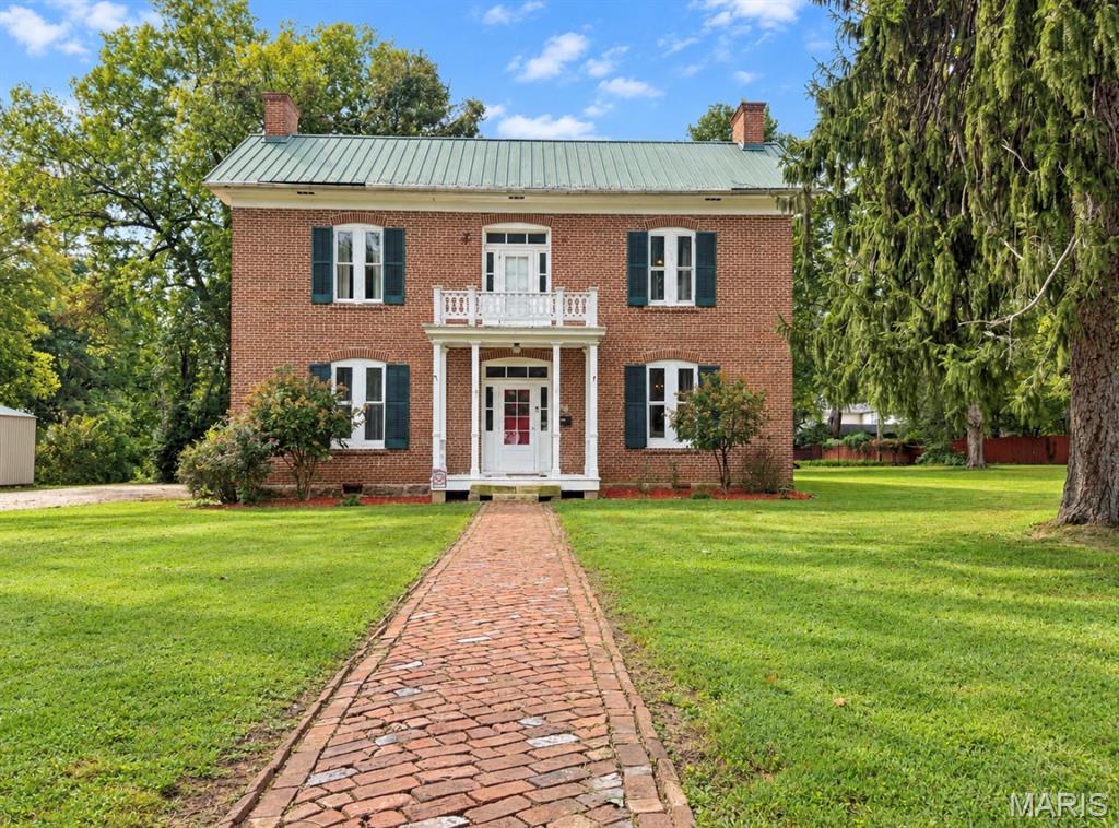 Step into a remarkable piece of local and national history with the McCormick House, built in 1875. This stately two-story historic residence offers a rare opportunity to own a home filled with original character, craftsmanship, and architectural details that have endured for generations. Situated on more than 3/4 of an acre, the property combines historic charm with generous living space, a spacious yard, ample parking, alley access, and a convenient location just minutes from downtown. Inside, the home offers four spacious bedrooms and one full bathroom, along with an impressive layout featuring two separate staircases, high ceilings, large original windows, and abundant natural light throughout. Beautiful natural hardwood flooring extends throughout much of the home, complementing the handcrafted brick exterior and timeless architectural details. Each bedroom offers generous proportions and retains an original fireplace, providing a unique reminder of the home’s 19th-century craftsmanship. The spacious living room offers plenty of room for gathering and entertaining, while the formal dining room provides an ideal setting for meals, holidays, and special occasions. A separate sitting room and charming breakfast nook create additional spaces to relax, read, entertain, or enjoy your morning coffee. The large laundry room offers plenty of functional space, while the attic provides excellent storage for seasonal items and household belongings. The property also includes a storm cellar, adding another practical feature to this historic home. Outdoor living is just as impressive. Enjoy the welcoming front porch or relax on the covered side/rear porch overlooking the expansive yard. With more than three-quarters of an acre, there is plenty of room to enjoy the outdoors while still being conveniently located close to downtown amenities. Another standout feature is the property’s original cook house, offering additional space that could be used for storage, a workshop, crafting area, hobby room, or other creative purposes. The home also features a durable metal roof and exterior walls constructed with beautiful handmade bricks that showcase the workmanship of the era. For history enthusiasts, the McCormick House presents an especially unique opportunity to own a tangible piece of history with recognized historical significance. At the same time, this is a home meant to be lived in and enjoyed. Future owners can make updates and renovations to fit their needs and personal style on the interior. This property also could be the perfect location for an office building for a business. So, Whether you are a first-time homebuyer searching for something truly distinctive, a history enthusiast drawn to original craftsmanship, or someone looking for a spacious home with character that simply cannot be recreated today, the McCormick House offers an extraordinary combination of history, space, location, and potential.