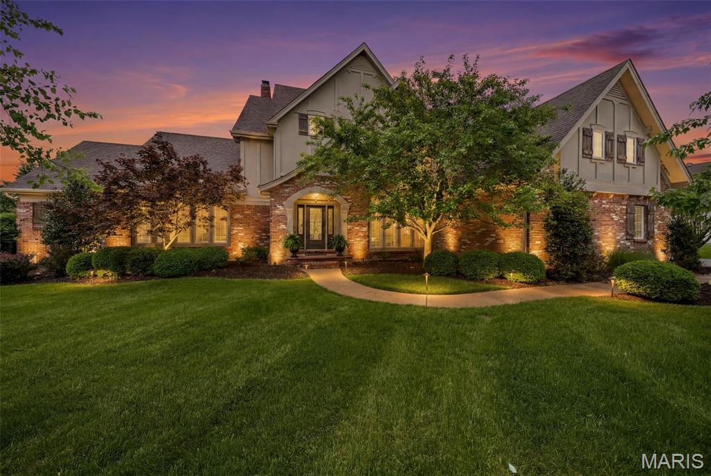 From the moment you step through the front door of this beautifully maintained 1.5-story home in the gated Pevely Farms golf community, the feeling is unmistakable. Soaring arched doorways, beautiful hardwoods, and walls of windows framing lush treetop views set the tone for a home that is as warm and livable as it is impressive. Nestled on a private, wooded cul de sac lot with nearly 6,500 square feet across three levels, this 5+ bed, 5 bath retreat is thoughtfully designed for both grand entertaining and multi-generational living. A home beautifully removed from the everyday, yet just minutes from highways, hiking trails, and championship golf.

The two-story great room draws you in with a glowing fireplace, custom built-ins, and natural light pouring in from every direction. The chef's kitchen offers custom cabinetry, a spacious island, walk-in pantry, and a custom bar around the corner, all flowing into a sun-drenched breakfast room with a coffered ceiling, statement chandelier, and wraparound windows that frame the pool and treetops below. The hearth room, anchored by a dramatic floor-to-ceiling stacked stone fireplace, opens through French doors to a covered screened porch with tongue-and-groove ceiling, string lights, and remote controlled screens leading to the second-tier composite deck, the kind of space where mornings start slowly and evenings linger. Main floor laundry, built-in cubbies, and a private home office round out the main level. The primary suite features coffered ceilings, his and her walk-in closets, and a private bath with a walk-in shower and jetted tub. Upstairs, three generously sized en-suite bedrooms and a flexible loft are filled with natural light.

The walk-out lower level is an entertainer's dream and a seamless extension of the nature surrounding you, with a kitchenette, wine storage, stone fireplace, and banquette all flowing directly outside to a stunning gunite pool, gas fire pit, and an oversized 8-person hot tub, all framed by a beautifully landscaped private acre of mature trees. Additional flex spaces include a bedroom, full bath, office, workout room, and media room, perfectly suited for guests or a fully private living suite.

The details that make daily life effortless are all here as well. Landscape lighting and an irrigation system keep the grounds immaculate through every season, a newer roof, hot water heaters, and updated multi-zone HVAC offer lasting peace of mind, and a three-car oversized garage handles everything else, all within the boundaries of top-ranked Rockwood R-VI Schools.

This is the rare home where luxury and nature exist in perfect harmony, where every season brings something worth savoring and every corner of the property feels like it was designed for living fully.