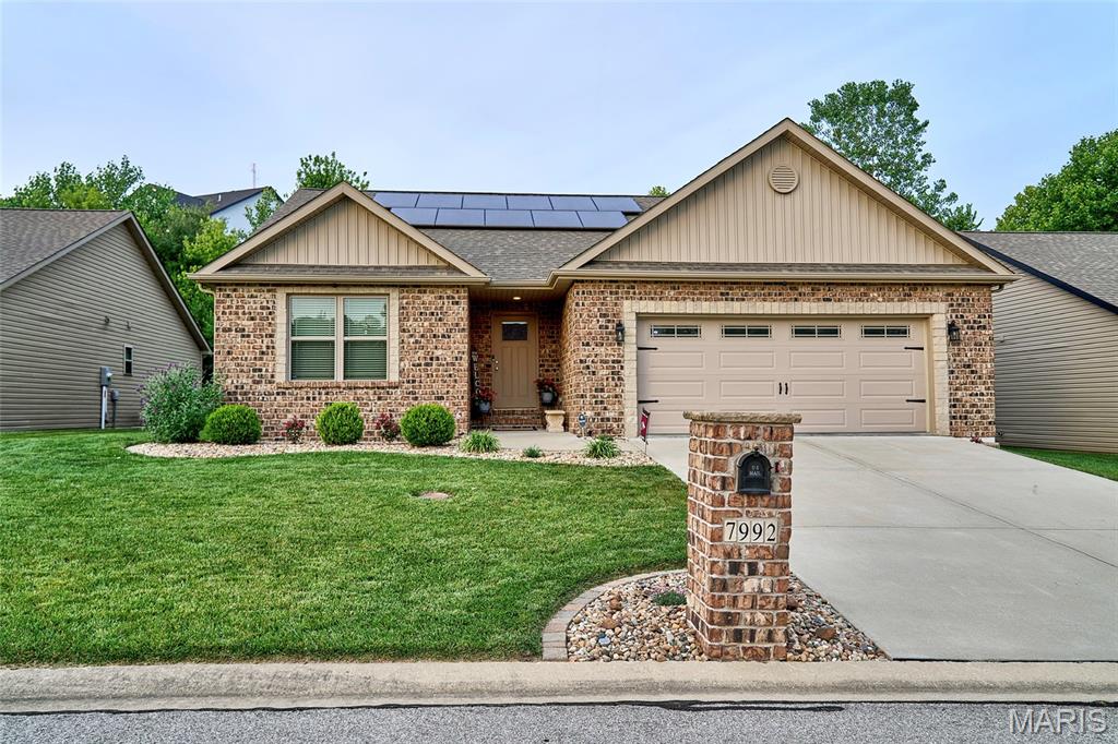 Welcome home to this beautifully appointed 2-bedroom, 2-bath residence in the highly desirable Tanglewood community. Thoughtfully designed with quality finishes and an open-concept layout, this home offers comfort, style, and room to grow. The spacious great room features a soaring vaulted ceiling and cozy gas fireplace, creating the perfect gathering space for family and friends. The kitchen is a standout with an 8-foot granite breakfast bar, 36-inch custom cabinetry with inset doors, crown molding, soft-close drawers and doors, roll-out shelving, tiled backsplash, pantry with adjustable wood shelving, and stainless steel appliances. A large double-basin stainless steel sink and abundant workspace make meal preparation a pleasure. Enjoy outdoor living from the composite deck just off the kitchen, with easy access to the private, fenced backyard accented by stylish black aluminum fencing creating a secure backyard providing a defined boundary and a safe play area for children and pets. The private primary suite boasts a vaulted tray ceiling, spacious walk-in closet, and a luxurious ensuite bath featuring an 8-foot granite vanity with dual undermount ceramic sinks, American Olean porcelain tile flooring, and a spacious porcelain tile shower. 
A generously sized second bedroom and full guest bath with granite countertop, undermount ceramic sink, and porcelain tile flooring provide comfort and convenience for family or visitors. Throughout the home, you'll find premium Novocore 100% waterproof luxury vinyl plank flooring, offering exceptional durability and modern appeal. The basement presents incredible potential, featuring a bath rough-in, egress window, and Champion Waterproofing lifetime warranty. Easily finish the space to create additional bedrooms, a recreation room, home office, or guest suite—adding substantial value and living space for years to come. Located in scenic Tanglewood, a picturesque 320-acre community designed for an active lifestyle, residents enjoy stocked ponds, walking and nature trails, a playground, miles of sidewalks, and golf-cart-friendly streets. Conveniently situated just 20 minutes from downtown St. Louis and Scott Air Force Base, this home offers the perfect blend of peaceful living and easy access to shopping, dining, employment, and entertainment. Don't miss this exceptional opportunity to own a quality-built home in one of the area's most sought-after communities.
