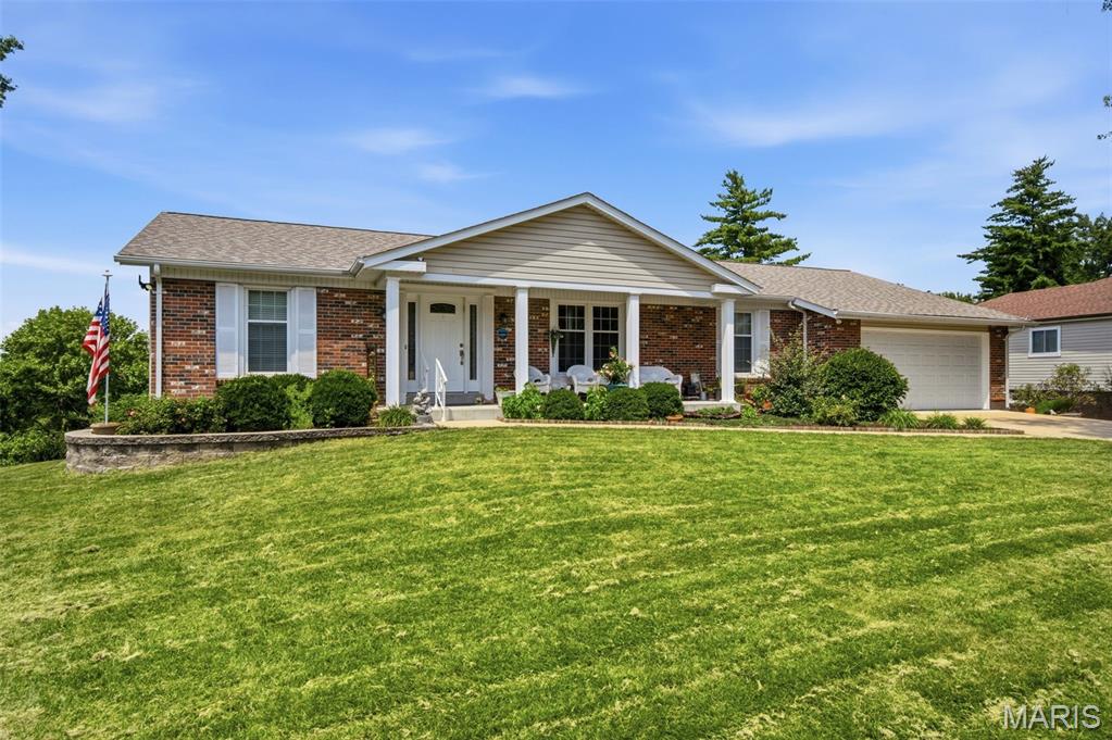 Experience the perfect blend of elegance, comfort, and resort-style outdoor living in this exceptional ranch offering over 3,000 square feet of beautifully finished living space. The open-concept design is highlighted by gorgeous hardwood floors, a cozy gas fireplace, recessed lighting, plantation shutters, and stylish modern fixtures throughout.

Designed for both everyday living and effortless entertaining, the home features a spacious living room, family room, private office/formal dining, and a beautifully appointed kitchen with 36-inch soft-close cabinetry, new refrigerator, a breakfast bar, and an adjoining dining area. Step outside to the maintenance-free composite deck and take in breathtaking waterfront lake views and spectacular sunsets that provide a stunning backdrop year-round.

The luxurious primary suite is a private retreat, complete with a walk-in closet, spa-inspired bath with Toto bidet & Jacuzzi shower, and direct access to a stunning new sunroom where panoramic lake views and extraordinary flower gardens create a peaceful, Zen-like escape. Two additional generously sized bedrooms, a full bath, powder room, and convenient main-floor laundry complete the thoughtfully designed layout.

The partially finished walkout lower level expands your living options with a dedicated fitness area and two versatile sound-proof bonus rooms. Walk out to the covered patio and enjoy the beautifully landscaped, fenced backyard featuring vibrant perennial gardens with a producing peach tree, a charming stone pathway on the south side of the home leading to the lake, and multiple outdoor living spaces.

Tucked away on a quiet no-through street, this home is a private sanctuary just minutes from Highways 270 and 40, top-rated hospitals, shopping, restaurants, parks, and everyday conveniences. With a two-car garage, picturesque waterfront setting, and impeccable indoor and outdoor spaces, this is a rare opportunity to enjoy lakefront living at its finest.