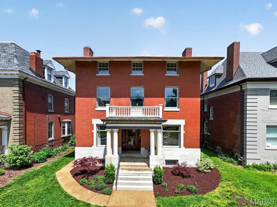 Nestled on one of the neighborhood's most coveted private streets, this magnificent 1901 residence is a rare blend of historic grandeur and contemporary comfort — truly move-in ready. A charming covered porch sets the tone, welcoming you into a home rich with architectural character. Soaring 10ft ceilings, original fireplaces crowned with ornate mirrored mantels, pocket doors, a sweeping bay window, and elegant crown molding speak to a craftsmanship rarely found today. Gleaming wood floors flow throughout the first and second levels, while front and rear staircases add to the home's stately presence. The thoughtfully designed floor plan lives as beautifully as it looks — an open-concept kitchen and living area create the perfect space for everyday living and effortless entertaining. The chef's kitchen impresses with custom shaker cabinetry, a center island, slate floors, and verde marble countertops. A convenient second-floor laundry and three-zone heating and cooling system add everyday ease. Retreat to the primary suite, where a recently-remodeled custom walk-in closet and spa-inspired bath with heated floors awaits. Three and a half baths total ensure comfort for family and guests alike. The expansive 3rd floor offers incredible versatility with a family room and additional bedrooms - used as office space — room to grow in every direction. Outside, a beautifully appointed patio with pergola creates an ideal setting for outdoor living, complemented by an oversized two-car garage. All of this, just minutes from acclaimed restaurants, world-class hospitals, Forest Park, and New City School.
