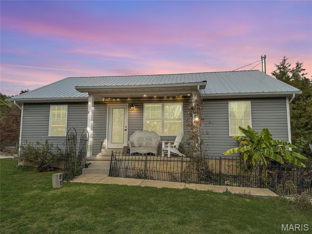 If you’ve been craving a place where modern living meets country calm, welcome home. Nestled on nearly 3 private acres, this beautifully built 2019 home combines comfort, versatility, and peaceful surroundings near Festus and Hillsboro.

You’ll instantly notice the openness, the way the light moves through the space and makes the home feel calm yet connected. With 3 bedrooms and 3 full bathrooms, every detail was designed to make life flow easily. The main level features an open floor plan where the living, dining, and kitchen areas come together naturally, perfect for everyday living or small gatherings. The kitchen feels clean and modern, with plenty of counter space and functionality for the way people really live. The primary suite on the main level offers privacy, comfort, and a full bath, while the additional bedroom can flex beautifully as a guest space, home office, or creative corner.

Downstairs, the finished walk-out basement expands your possibilities even more, complete with an additional bedroom, full bathroom, and living area that opens directly to the outdoors. The basement layout creates a sense of separation while still feeling part of the home, offering flexibility.

Outside, you’ll find nearly 2.86 acres of peaceful land, a rare balance of privacy and space without the overwhelming upkeep of a full farm. Enjoy evenings on your deck watching the sunset, mornings with coffee surrounded by nature, or dream bigger with gardens, outdoor entertaining areas, or even room for a workshop or small stable. Because it was built in 2019, this home gives you the peace of mind that comes with newer construction,  efficient systems, modern design, and low maintenance living. Everything feels cared for and move-in ready. Located just minutes from the heart of Festus, you’ll have quick access to shopping, schools, dining, and highway connections, while still coming home to your own private retreat.