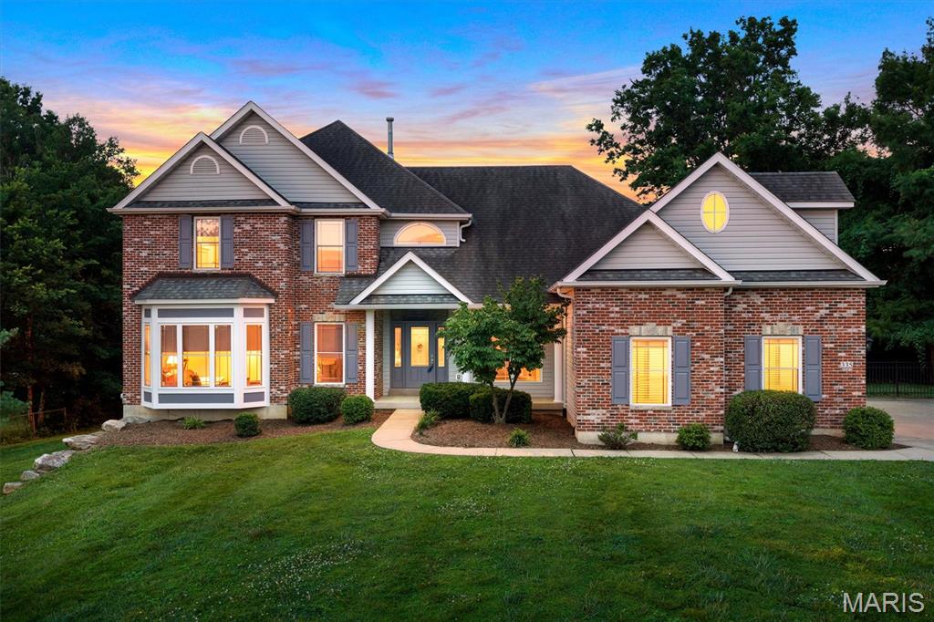 Welcome home to 335 Summit Rd in Fenton, where space, privacy and an incredibly versatile floor plan come together in LINDBERGH SCHOOLS. Beautifully maintained and situated on a private .76-ACRE LOT, this custom 1.5-story home offers over 5,300 SQ FT of living space, 5 bedrooms, 6 bathrooms and a 3-CAR SIDE-ENTRY GARAGE—with room for everyone to spread out, gather together and truly feel at home.

Step inside to a light-filled TWO-STORY GREAT ROOM with one of 2 GAS FIREPLACES, creating a warm centerpiece for everyday living. The spacious kitchen opens to a cozy hearth room with the second fireplace—the kind of space where everyone naturally gathers. A formal dining room provides plenty of room for holidays and special occasions, while the MAIN-FLOOR PRIMARY SUITE offers a peaceful retreat with TWO WALK-IN CLOSETS. Main-floor laundry adds everyday convenience, and a separate bonus room with its own staircase is perfect for a home office, movie room, playroom or creative space.

The FINISHED WALK-UP LOWER LEVEL feels like an extension of the home rather than a typical basement, with a 9-foot foundation pour, large windows bringing in abundant natural light, a spacious family room, bedroom and full bath. An additional entrance directly from the garage—with easy access for moving furniture—also creates a fantastic setup for MULTIGENERATIONAL LIVING, extended family or long-term guests.

Outside, the large FENCED BACKYARD gives you something increasingly hard to find: room to breathe. Host summer barbecues, create the garden you've always wanted, let kids or pets play, or simply enjoy a quiet evening surrounded by your own private space. Exceptionally well cared for, incredibly spacious and tucked into a private Fenton setting, 335 Summit is a home designed to be lived in and enjoyed for years to come. And with NO HOA telling you how to enjoy your property, there's even room for the chickens!