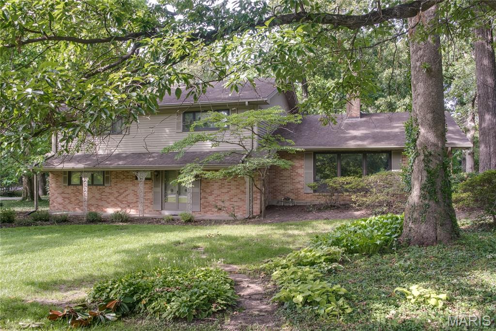 Unique opportunity to create your own dream home in a fabulous sought-after Frontenac Forest. Situated on an enormous lot, the park-like setting offers privacy and a prominent position in the Frontenac Forest enclave and features a charming dry creek drainage on a far side of the property with walking bridge. This mid-century modern muti-level provides great living and entertaining space with elements that aren’t easily reproduceable. Enter through the custom stone entry with indoor fountain through double doors to the floating, curved, concrete staircase. That main level features a guest bedroom, formerly a library, revamped hall bath and a multi-purpose family room with wet bar and access to the sprawling covered patio large enough for plenty of guests. The second level houses the formal living room, formal dining room and updated chef’s kitchen. Splitting the dining and living areas is a floor to ceiling st5acked stone cylindrical gas fireplace harkening back to the middle century all bathed by natural light though the bank of floor to ceiling windows. Also on this level the kitchen features a cozy eat in area with gas fireplace. You’ll find plenty of granite countertop workspace all around the perimeter as well as a center island with gas cooktop, fume hood and dishwasher concealed to match the cabinets . Plenty of custom cabinets with pullouts and matching granite backsplash and large format ceramic tiles in a durable yet very upscale design. Newer double wall ovens, Microwave and French door refrigerator included in stainless steel. There is easy access from the kitchen to the screened in patio. Continuing up the floating curved staircase, the third level is the private residence area with three large bedrooms, all with wood flooring, a hall bath, and the primary suite with ensuite bath. The lower level has a finished area, built-in in cedar sauna plus plenty of storage and utility area. The covered patios is immense in two levels featuring Italian terracotta tile, an exposed joist ceiling, skylights, and ceiling fans. There is a sloped glass ceiling in the separately enclosed section with hot tub spa. Oversize two-car attached garage on the main level, dual HVAC zones. This home is ready for you to put your own designs on and enjoy the tranquility of the mature trees and privacy. Top rated in the state Ladue Schools, Conway Elementary. Situated minutes from major transportation corridors, Clayton, West County Access, upscale shopping and dining.