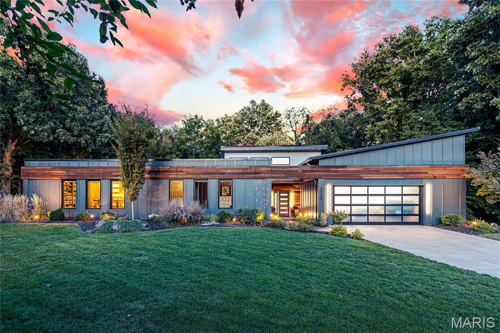 Sensational mid-century contemporary redefined & expanded while maintaining the distinctive character & design elements of the original architecture. Over 4500 sq ft of living space enhanced by wide plank hickory flooring, soaring ceilings, detailed trim work & expansive windows with private wooded views. Galley hallway with domed skylights leads to state-of-the-art kitchen with custom cabinetry, quartz countertops, Cafe appliances & 10' center island and light-filled dining room. Step down to stunning great room with 12’ ceiling & floor-to-ceiling stacked stone fireplace and beautifully appointed primary bedroom suite with luxury bath with freestanding tub. Hardwood floors continue to the 2nd level with 2 additional bedrooms & full bath. Lower Level includes recreation room & game room plus workout room, 4th & 5th bedrooms, sauna & full bath. Sliding glass doors open to outdoor living area with wrap around deck, resort style pool & pergola surrounded by landscaped gardens.