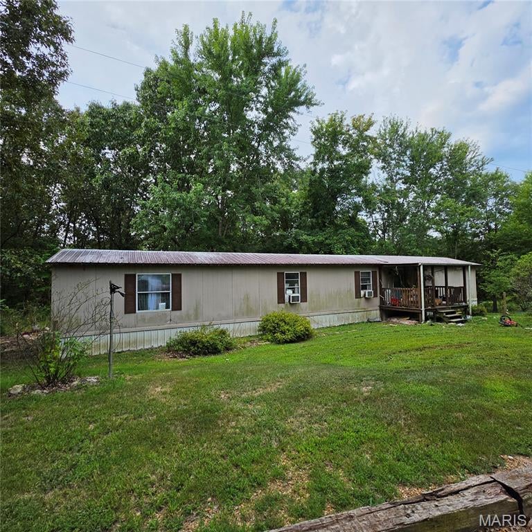 Remodeled 3-bedroom, 2-bath manufactured home on 5 acres, set back from the road for added privacy. Features include a 500 sq ft addition, built-on front porch, fenced front yard, garden shed, private well, and septic. Woods at the back of the property offer room to explore, and a chicken coop is included for homesteading potential.