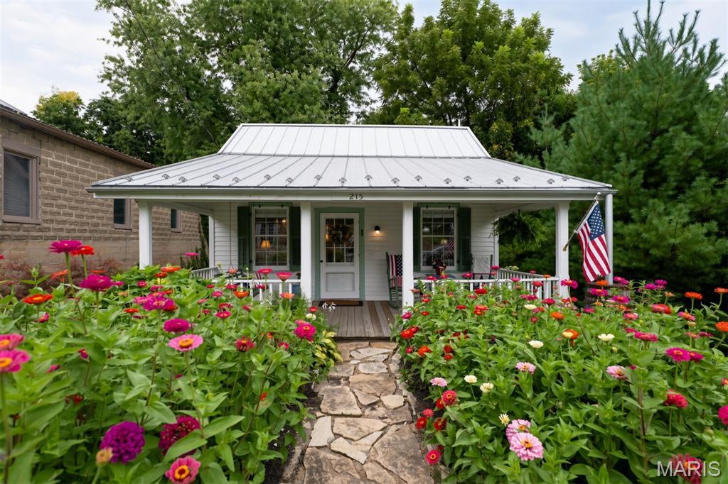 Welcome to this beautifully restored 1800s cottage in historic Augusta, Missouri—the gateway to wine country! This is your once in a lifetime opportunity to invest in America's first official 'American Viticultural Area' (AVA). Augusta, Missouri is enriched with history and centuries of settlers like Daniel Boone. 
This quaint 1-bedroom, 1-bathroom gem boasts a remarkable history and rich historic craftsmanship. Currently thriving as an active, successful short-term rental, this property offers incredible versatility. 
Whether you are looking for a turnkey investment property or a peaceful personal getaway, this unique piece of Augusta history is ready for its next chapter. 
A Rich Historical Legacy saved from Destruction: Originally built in the Missouri River Bottoms,just southeast of Augusta, a portion of this historic home was rescued around 1960 by Darold Rhinedollar.  Mr. Rhinedollar, the town's last local blacksmith, carefully moved the structure to its current site next to his historic operational livery building, which still stands today. A historical architect notes that the home's original glass windows likely date back to the 1700s and were brought to the area by boat via the Missouri River. The current owners had custom storm windows made to protect and preserve these windows. 
Over the decades, this resilient building served as a beloved antique shop before being lovingly transformed into a successful Bed & Breakfast in 1998. In 2020 the home had renovations and new standing seam roof along with the timeless half round gutters. The current sellers at this point decided they would share their love for The Cottage with others and create a short term rental. 
Thanks to Mr. Rhinedollar's exceptional care during the relocation, combined with modern updates and meticulous ongoing maintenance, this solid little house is structurally sound and built to last another 100 years. 
Schedule your visit and experience the unmatched tranquility of wine country living. The Cottage has potential to make your business dreams come true. 
Call for your private tour today to witness this historic masterpiece in person!