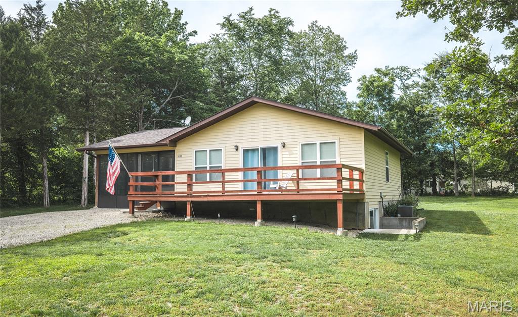 This could be your perfect getaway place! Located within walking distance of cove 5 so you can easily launch your boat, fish, or jump in for a swim! Sitting on two lots to give you some privacy. The screened in porch is huge and this is where you will live all summer long! Sliding glass doors at the front of the house bring in lots of natural light and give you access to the deck. An open floor plan with living/dining/kitchen area allows for easy entertaining. The main level has two full bedrooms, one features an en suite half bath. Another full bath is on this level. The unfinished lower level has a walk out so it could be converted to usable living/bedroom space. The full bathroom is completed for you! Indian Lake is a 326 acre (+/-) lake that members can use for ALL the watersports. Boating, skiing, tubing, jet skis, fishing and swimming will fill your sunny days of summer. There is a sandy beach with pavilions and a playground. Basketball, tennis/pickleball, baseball and horseshoes are additional activities. The community center hosts various activities throughout the year including trivia nights, bingo nights, potlucks, poker runs and more. The community center can also be rented for private events. A full service marina make lake life easy providing boat, golf cart repair and offering essentials at the general store.