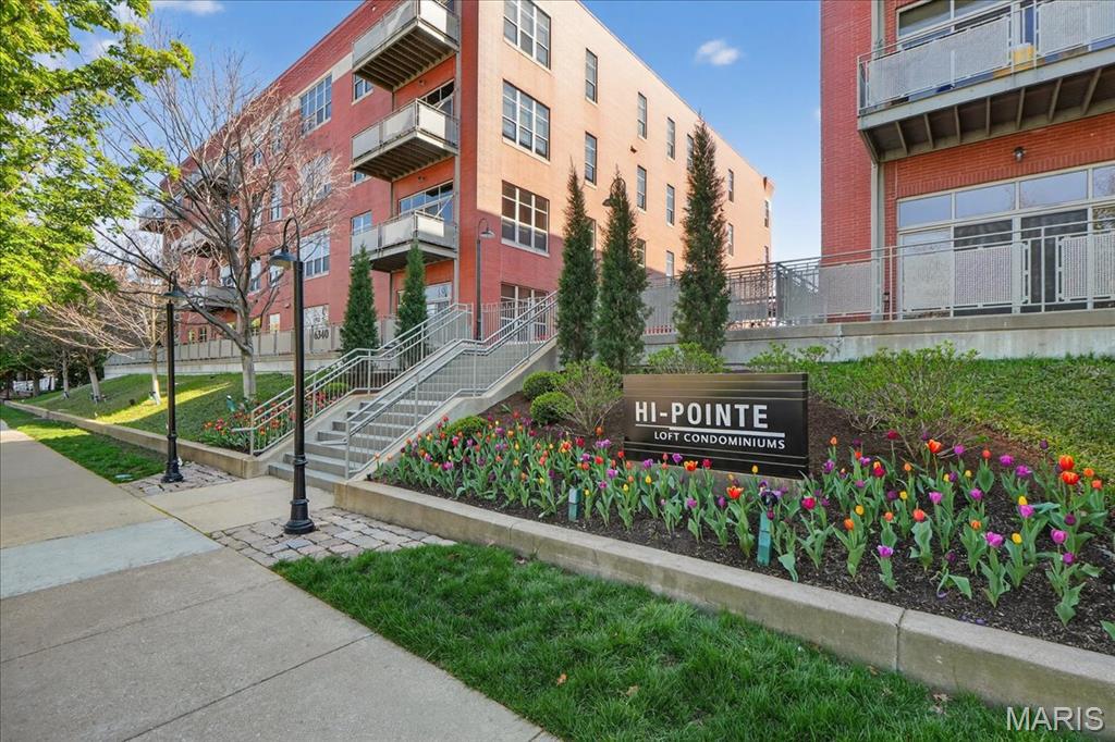 Sophisticated 2 bed, 2 bath one-level living with rare private outdoor space in a prime, walkable location. This corner residence features 11' ceilings, dramatic 9' windows, and new flooring throughout, creating a bright, refined feel. The spacious kitchen offers granite countertops, stainless steel appliances, and generous prep and storage space. A custom built-in bookcase with ladder adds striking architectural character. The primary suite includes a large bedroom, walk-in closet with custom built-ins, and a well-appointed bath with dual vanities, separate tub and shower. The second bedroom features a custom Murphy bed and is conveniently located near the updated hall bath, ideal for guests or flexible use. Enjoy the private patio, walk-in utility room, and effortless layout designed for easy living. Elevator building with two dedicated parking spaces in a climate-controlled garage. Unmatched access to Hwy 64 40, near Washington University, the Central West End, and downtown Clayton. Walk to Forest Park, neighborhood wine shop, and more. Clayton Schools. Truly move-in ready.