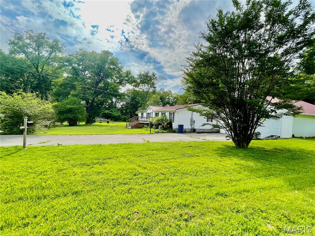 Well maintained home with 3 lots estimated at 1.17 acres!! 3 BR / 2 BA, basement, den, attached breezeway leading to the oversized 2 car garage. The home and BOTH adjacent properties are including in this sale!!