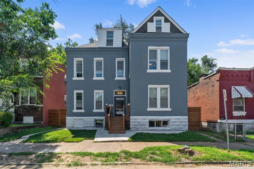 This beautifully updated 3-story home offers an impressive amount of living space with a flexible layout from top to bottom. The main level features an open and inviting living area with exposed brick, an electric fireplace, recessed lighting and a spacious dining area that flows into the oversized kitchen. The kitchen is built to entertain with abundant white cabinetry, stainless steel appliances, a statement backsplash, generous counter space and a large center island with seating. Upstairs, the second floor offers 3 bedrooms, including an expansive primary suite complete with a large walk-in closet, private bath with double vanity and oversized tiled shower, plus access to a large private balcony overlooking the backyard. Two additional bedrooms share a convenient Jack-and-Jill-style bath. Continue to the third floor where you’ll find 2 more generously sized bedrooms and another full bath. The finished lower level adds incredible versatility with its own full kitchen, full bath, living area and 2 additional sleeping rooms—ideal for extended living, guests, a home office setup or recreation space. Outside, enjoy a large fenced backyard, covered rear deck, upper balcony and an oversized detached garage. With multiple levels of finished living space and room for nearly every need, this is a home you truly have to see to appreciate!