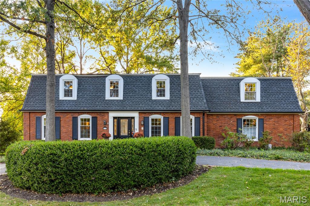 Outstanding two-story in premier location offering luxury, comfort, and thoughtful updates throughout. Rich oak hardwood floors extend across both the main and second levels, creating warmth and continuity in every room. A custom leaded glass entry opens to a gracious foyer, formal living and dining rooms with crown molding and full-height windows, and an inviting family room featuring a beamed ceiling and atrium doors to a screened porch—ideal for seamless indoor-outdoor living. The designer kitchen is both striking and functional, with large walk-in pantry, appointed with quartz countertops, Shaker cabinetry, commercial-grade appliances, and an impressive 7-foot center island perfect for gathering and entertaining. Upstairs, hardwood flooring continues throughout the second level. The spacious primary suite offers a large walk-in closet and an updated and luxurious bath. Four additional bedrooms, two full baths, and a convenient second-floor laundry room complete the level. The finished lower level includes a generous recreation room, fitness studio, and full bath, providing versatile space for relaxation or recreation. Set on 1.07 acres of park-like grounds, the property features a patio, pool, circular drive, and attached two-car garage.