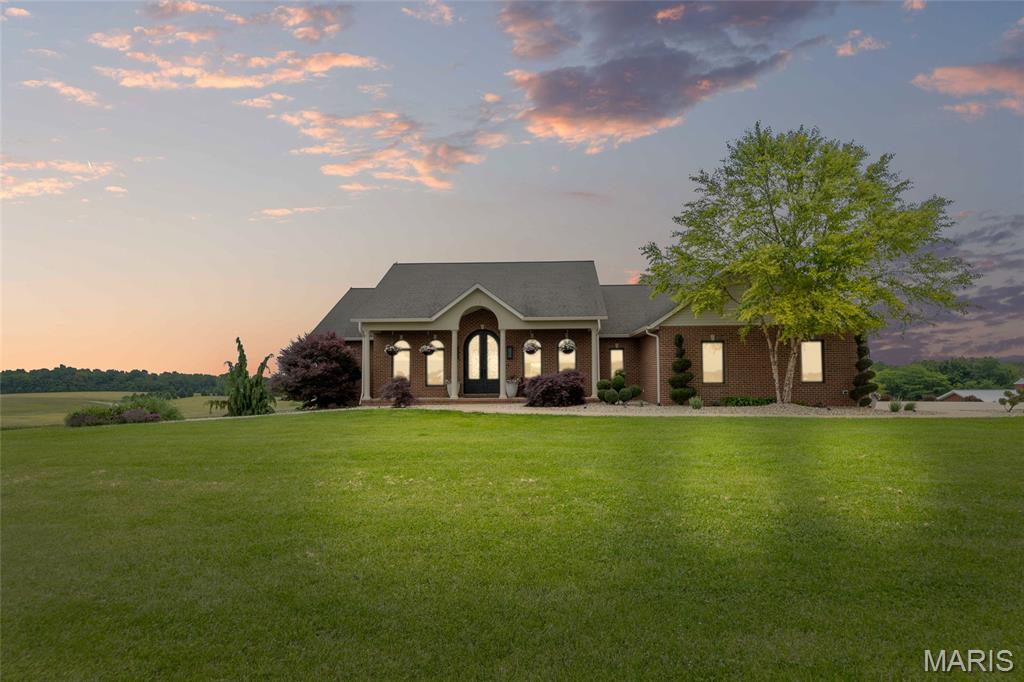 Meticulously maintained 19.73 acre equestrian estate on Crowe Farm Road, just 10 minutes from Waterloo, IL. This private retreat features a 4-bed, 4.5-bath atrium brick ranch with a split floor plan, blending custom design with peaceful country living. Built in 2007. 11' ceilings, hickory hardwood floors, and a gourmet kitchen with DCS & Miele appliances—including a built-in plumbed espresso machine plus the duel fuel gas range top and 2 electric ovens in addition to the wall oven and dream walk-in pantry with quartz countertops. Three main-level bedrooms have ensuite baths and walk-in closets. The finished walkout basement offers a media room, office, custom bar, and wood-burning fireplace. Enjoy energy savings with a 28KW solar system and whole-house generator. Morton horse barn includes 4 stalls, grooming & wash stalls, wide aisles, French drains, plus tack room with a sink and Kraftmaid cabinetry with Granite countertops. Additional outbuildings include a hay barn with storage room (added in 2022), a chicken coop, riding arena, and fenced corral. Outdoors: 3(m/l) ac stocked pond with riprap & 2 paddle boats, 3.75(m/l) wooded ac with trails and deer stands, and 5.5(m/l) ac hay field. Relax on the screened porch overlooking your private paradise and watch the wildlife. Other highlights include a deep well, whole-house filtration, Culligan softener, geothermal HVAC, SimpliSafe security, central vac, and extensive LED lighting updates throughout.