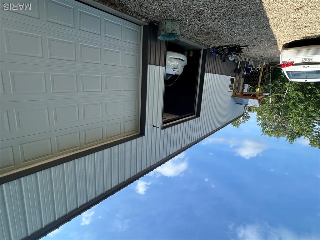 If you are looking for a private setting close to town and I44 then you will be interested in this property. Sitting on over 5 acres this unique house could be called a Shouse! 
Rustic in design, this 5 year old home is all electric, has 3 bedrooms and 1bath. The kitchen opens to a 4+ bay garage with workspace and14 ft. ceilings. The pictures do not do credit to the size of the garage!!Plenty of room to work and have storage. 
a lift does not stay at this time. There is one loft in the garage section that could be used for storage or to be a second bathroom. There is plumbing accessible from this loft area for a second bathroom that could have an entrance from the second bedroom in the upper level of the living quarters. The main level living area is an open concept design that includes the kitchen, dining area and living room. The living room has an electric fireplace that definitely helps with heating in the winter. The central part also has 14 ft. ceilings. This area could be adapted to various floor plans to have a bigger kitchen, more cabinetry and an island or wrap around counter space. The main level has concrete flooring. There is under the stair storage and a walk in closet that also shows the back of the TV with the hookups. Very convenient! The main level also includes one bedroom and one bathroom. Both are 20ft long and 12ft wide. Lots of possibilities. The large bath has the mechanical closet with the hot water heater, furnace and pressure tank. The full size washer and dryer are also in this bathroom. Lots of central floor space that could also be arranged to provide this room with more storage and counter space. Upstairs is a loft sitting area overlooking the downstairs open living space and additional two bedrooms both 20ft. long and 12ft. wide.  The flooring in the upstairs is plywood.  The home is metal sided with blown foam insulation throughout all the walls and under the metal roof. You can see this in the garage. Outside there is a large yard with another outbuilding that is currently being used as a garage. It can be converted to other uses as needed.  The yard has plenty of room for a garden and is surrounded by woods. Just a little into the tree line is a log bridge to get over a wet weather run off.  The well and septic are not over 5 years old. There is so much a new owner could do with this property!  Shamrock Lane is a private, gravel road.  No restrictions. This property is close to the Meramec River with a put-in area just down Hwy N.