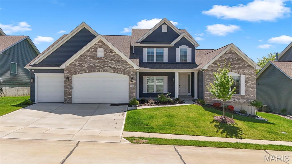 PRICED TO SELL--  Welcome to this beautifully crafted 1.5-story home offering the perfect blend of modern design and everyday comfort. Built in 2024, this home feels brand new and features high-end finishes, thoughtful details, and an open, airy layout ideal for both relaxing and entertaining.  The main level showcases a spacious living area filled with natural light, seamlessly flowing into a stylish kitchen complete with sleek cabinetry, premium appliances, and a large center island. The main-floor primary suite provides a private retreat with a luxurious ensuite bath and generous closet space.  Upstairs, you’ll find additional bedrooms and flexible living space—perfect for guests, a home office, or a growing family. Brick Front. Every inch of this home has been designed with functionality and style in mind.  Enjoy the benefits of new construction without the wait, plus modern systems for efficiency and peace of mind. Whether you're hosting or unwinding, this home offers the space and sophistication you've been looking for.  4500+ sq ft of living space.  Open Floor Plan.  Lots of Natural light.  Upgraded kitchen with solid surface counter tops. 5 burner gas stove, butler space and large pantry, stainless steel appliances, cellular shades. Sunroom for entertaining. Hearth Room with 5 built in speakers and Cat6A wiring installed. Main Floor Primary Bedroom with tray ceiling. Primary bath with dual vanity, soaker tub and walk-in shower. Partially Finished lower level with bedroom and full bath. Central vacuum system throughout house. Main floor laundry, utility sink. LVP upgraded flooring in kitchen and bathrooms. 3 car garage. Security system. Front of the home faces North.