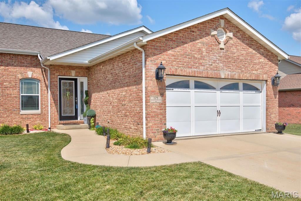 The current tax assessment reflects both side of the villa.  The property will be surveyed prior to closing & future taxes will reflect only the subject property. Luxury meets timeless elegance in this one of kind full brick villa. Rich travertine tile sets the tone in the inviting living room. The vaulted great room flows into the beautifully updated kitchen featuring stunning Brazilian quartzite countertops, farmhouse sink, and designer faucet.(2025) Convenient main floor laundry includes washer and dryer. The private primary suite offers a spa inspired bath with double bowl vanity, jetted tub and walk-in closet. The finish lower level expands your living space with a spacious family room featuring a wet bar( separate freestanding sink) third bedroom, full bath and a dedicated room with refrigeration in place for a wine cellar or tasting room. Unwind on the covered patio while enjoying peaceful views of neighboring corn fields. This exceptional villa with custom finishes is truly one of a kind. Seller will have lot surveyed with new PID prior to closing.