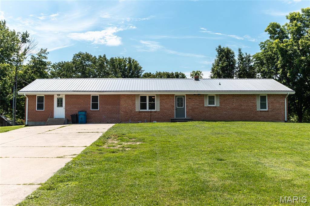 Nestled in a charming community, this spacious home offers the perfect blend of small-town living & versatile living space. Located just 45 minutes from Jefferson City & the Lake of the Ozarks, you'll enjoy a peaceful setting without sacrificing accessibility. The main level features 3 bedrooms, including a primary suite with its own full bathroom, along with a second full bath for family & guests. The kitchen serves as the heart of the home & comes with all appliances, including the washer & dryer, making your move easier. Downstairs, you'll discover additional living space designed to adapt to your needs. A 2nd family room creates the perfect spot for movie nights or relaxing. The large recreation room, previously used as a daycare, offers endless possibilities & could easily become a home gym, hobby area, mother-in-law suite, or even be reconfigured to add additional bedrooms. A convenient half bath & wet bar make this level ideal for entertaining or multi-generational living. Storage will never be an issue thanks to the oversized storage room, perfect for a workshop or canning room. Schedule your private showing today and see all the possibilities this unique home has to offer!