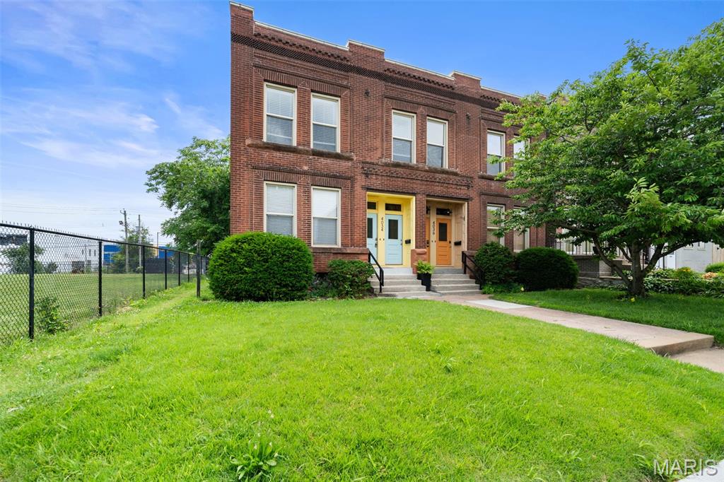 Experience the perfect blend of historic St. Louis charm and modern comfort in this spacious first-floor condo located in the heart of the Central West End. This beautifully maintained unit features soaring ceilings, exposed brick accents, gleaming hardwood floors, and an open-concept layout designed for both everyday living and entertaining.

The inviting living room showcases an exposed brick decorative fireplace and abundant natural light, flowing seamlessly into the updated kitchen complete with ample cabinetry, black appliances, and a large center island with breakfast bar seating. A long hallway with exposed brick walls leads to two generously sized bedrooms, including a primary suite with a private bath and large closet.

Step outside to enjoy a covered rear deck overlooking the shared fenced backyard—perfect for relaxing, grilling, or entertaining guests. Additional features include in-unit laundry, off-street parking access, and a prime location just minutes from Forest Park, BJC/WashU Medical Campus, Cortex Innovation District, restaurants, shopping, and nightlife.

Whether you're looking for a low-maintenance primary residence or an investment opportunity in one of St. Louis' most desirable neighborhoods, this Central West End gem is a must-see.