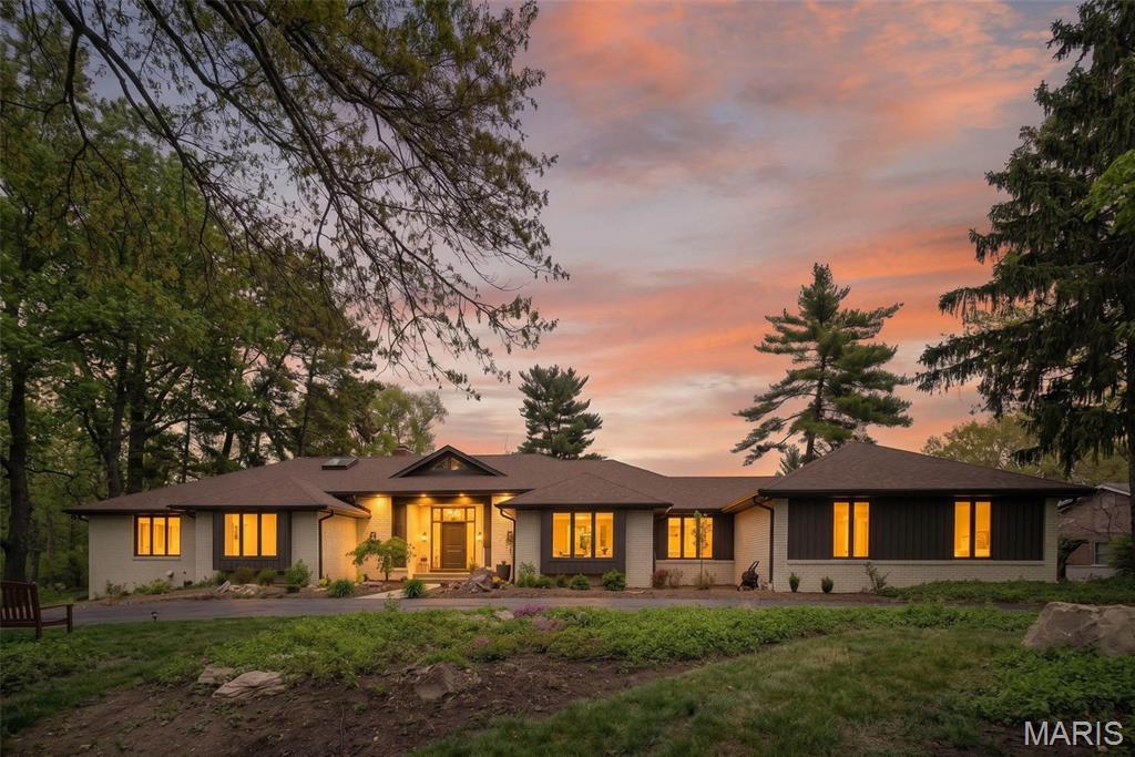 Nestled privately in the prestigious Ladue Farm Estates, this exceptional mid-century modern residence offers nearly one acre of serene, tree-lined privacy, backing directly to the tranquil beauty of Hunters Farm. A rare and captivating blend of timeless architectural character, thoughtful modern updates, and true resort-style living awaits.
Built in 1981 and meticulously refreshed with care, the home exemplifies classic mid-century design through its clean lines, soaring open spaces, and effortless indoor-outdoor connection. The heart of the home is the stunning, brand-new kitchen—a sophisticated culinary masterpiece featuring sleek stone countertops, a stylish statement backsplash, custom cabinetry, and not one, but three generous islands perfect for both everyday living and grand entertaining. High-end appliances complete the space, including a Dacor double oven, Sub-Zero built-in refrigerator, and Wolf cooktop.
The main living area impresses with dramatic vaulted and beamed ceilings, walls of expansive windows that flood the space with natural light, and a showstopping fireplace that serves as the warm, stylish anchor of the room. The thoughtfully designed open floor plan creates an airy, inviting atmosphere while allowing seamless flow throughout the home.
This residence offers four spacious bedrooms, with the primary suite serving as a luxurious private retreat complete with elegant finishes and thoughtful details. Several bathrooms have been beautifully updated, artfully blending modern comfort with timeless sophistication. In total, the home features seven bathrooms, providing exceptional functionality and space for family, guests, and everyday convenience.
Step outside to discover your own private oasis. The expansive, nearly one-acre lot delivers unmatched privacy and picturesque wooded views. At the center is a sparkling in-ground pool that creates a true resort-like experience right at home. A separate pool/guest house adds remarkable versatility—ideal as guest quarters, a private home office, a creative studio, or a personal sanctuary. Generous patios and multiple outdoor dining areas make year-round entertaining effortless and unforgettable, whether enjoying a quiet morning coffee or hosting lively gatherings under the stars.
This is a rare opportunity to own a beautifully updated mid-century modern masterpiece on a premier lot in one of St. Louis County’s most sought-after neighborhoods. Here, architectural style, abundant space, and an idyllic setting come together in perfect harmony—creating a home that truly lives as beautifully as it looks.
~ Near Westminster Christian Academy, Parkway Central, Maryville University, STL Priory School, Missouri Baptist, Visitation Academy, Principia School  ~  Near St Luke’s Hosp., Mercy Hospital, Missouri Baptist.