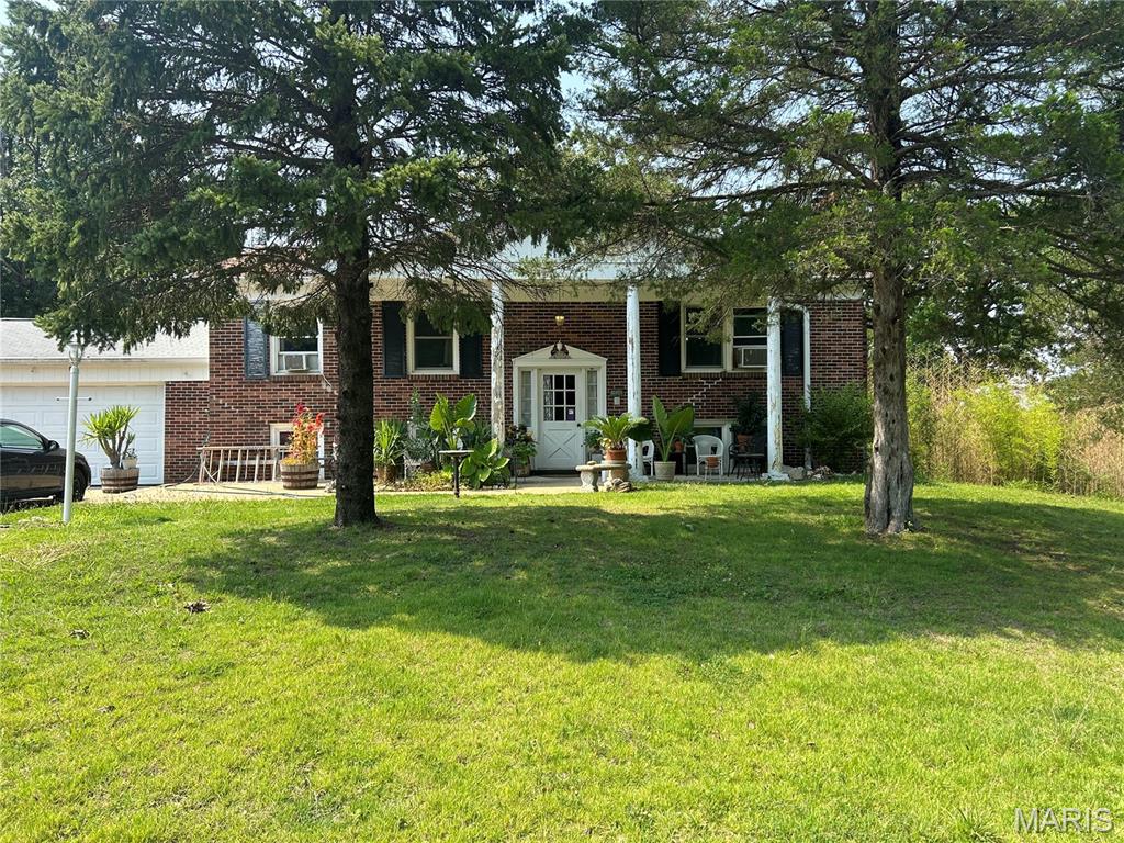 This spacious 4-bedroom, 2-bath split-level home is located in the beautiful Terre du Lac lake community and sits on three level lots, bordered by streets on three sides for added privacy and easy access.

The home features a cozy wood-burning fireplace in the main-level living room, along with a second wood-burning fireplace in the lower-level family room. Both levels offer two bedrooms and one full bathroom, providing a functional layout that's perfect for families, guests, or multi-generational living.

Accessibility is enhanced with a handicap-accessible ramp located at the rear of the home. The attached two-car garage includes an additional finished room that would make an ideal craft room, workshop, hobby space, or "she shed."

Enjoy the outdoors from the large screened-in porch/deck that spans the entire length of the back of the home, offering plenty of space for relaxing or entertaining. A concrete driveway leads to the garage, with an additional gravel parking area beside the driveway for extra vehicles, a boat, or RV parking.

Located in the sought-after Terre du Lac community, this property offers the perfect combination of comfort, space, and access to all the amenities of lake living.