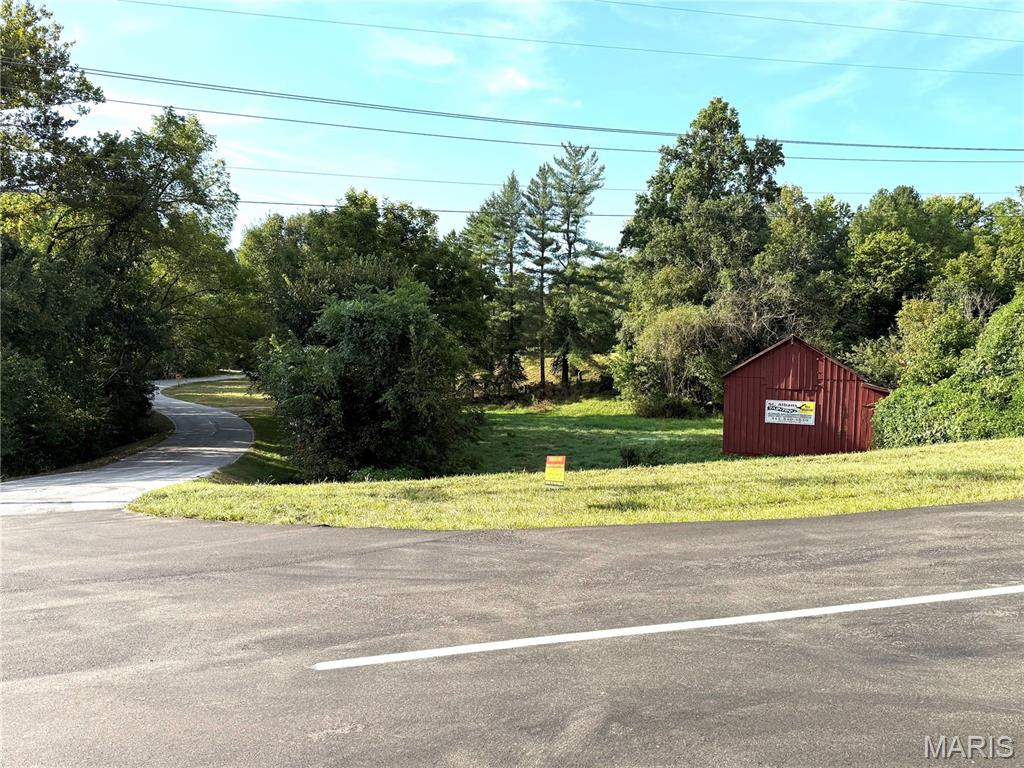 Welcome to 3135 Bassett Rd in Pacific, Missouri—a rare 10.5-acre country property with a 1930 farmhouse. Set along a scenic Franklin County road west of St. Louis, this expansive homesite delivers the space, privacy, and flexibility buyers seek for either 1, 2, or 3 building sites, a large barn, storage buildings, and perhaps keep the existing house to live in during the construction of a new house.  This house is off of Hwy T. only 1/2 mile west of the entrance to St. Albans Country Club.  Franklin County, so lower taxes, fewer rules, and less noise.   If you are tired of a busy subdivision, with HOA rules and nosey neighbors who are loud, then this may be the spot for you.  This listing is for the 10.5 acres and the rest of the buildings.  Also consider dividing the 10 acres into 2 - 5 acre parcels.  For some history....the property at 3135 Bassett Road was settled by Christian Hardt in 1840, then called Tavern Creek Farm. Christian was the first teacher at the Tavern Creek school in St Albans. Five generations of his family has lived on this property.  As a small farm over the years having livestock from cattle, horses, pigs, sheep, and later bison. All while growing a large abundant vegetable garden.  Enjoy a peaceful setting with convenient access to Highway 100 in Wildwood, and down Hwy 109 to Hwy 44 in Eureka.  Restore the original home, expand, or create your next chapter on this generous lot.  Choose the south driveway and look for the arrow to enter.  Walking the 10.5 acres is easy and arrange through ShowingTime.  The house is being sold in As-Is condition.  Home is still being detailed so no inside showings yet.