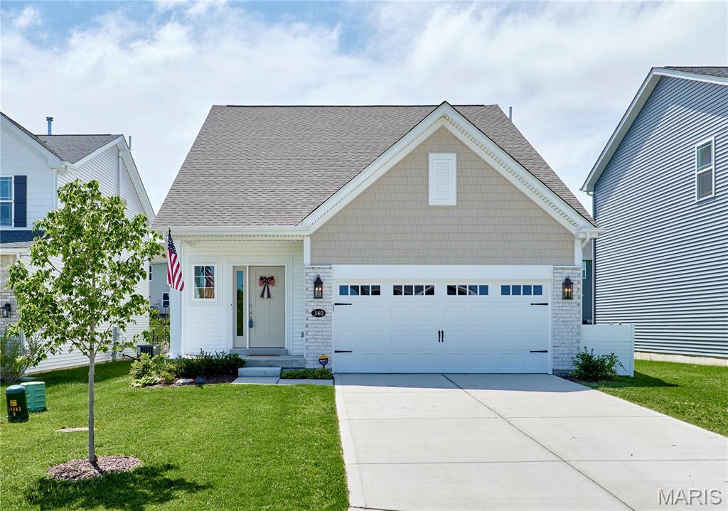 This nearly new Fischer & Frichtel Fairfax 1.5-story home, built just 2.5 years ago, offers excellent space and modern living in one of the area’s most desirable neighborhoods. Featuring four bedrooms and three bathrooms, along with a recently finished lower level, it provides flexible living options for today’s families. The thoughtfully designed main level features an open-concept layout with 9-foot ceilings and an expanded living area that fills the home with natural light during the day and is equipped with plenty of lighting for the nighttime. The kitchen stands out with its oversized island, quartz countertops and backsplash, and impressive floor-to-ceiling cabinetry — perfect for both everyday meals and entertaining. On the main level, the primary suite offers a private retreat with double separated vanities, a large walk-in shower, and a spacious walk-in closet. Upstairs you’ll find three additional bedrooms, a full bathroom, and a versatile bonus room that works well as a home office, playroom, or extra living space. The finished basement adds significant value with ample room for a second living area or kids’ play space, plus a multipurpose room complete with an egress window — ideal for a home gym, office, or future bedroom. A rough-in for an additional bathroom gives you room to grow and is waiting for your finishing touches. Built with a long list of quality builder upgrades — from lighting to finishes — zoned HVAC to 50 Gallon water heater — this home is move-in ready and designed for easy, comfortable living.